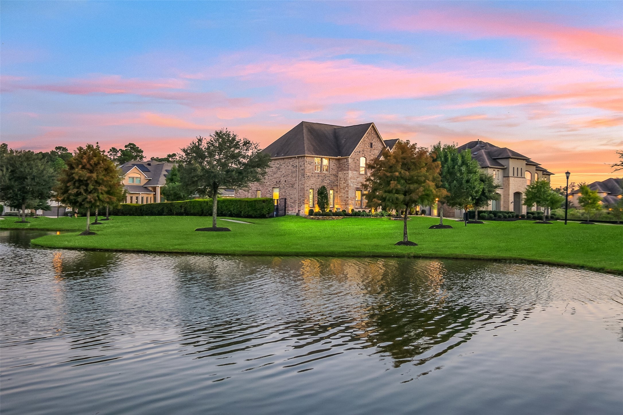 As twilight settles in, this home's brick and stone exterior glows warmly against the backdrop of the neighborhood pond a reminder of just how private and picturesque this setting truly is. As twilight settles in, this home's brick and stone exterior glows warmly against the backdrop of the neighborhood pond a reminder of just how private and picturesque this setting truly is.