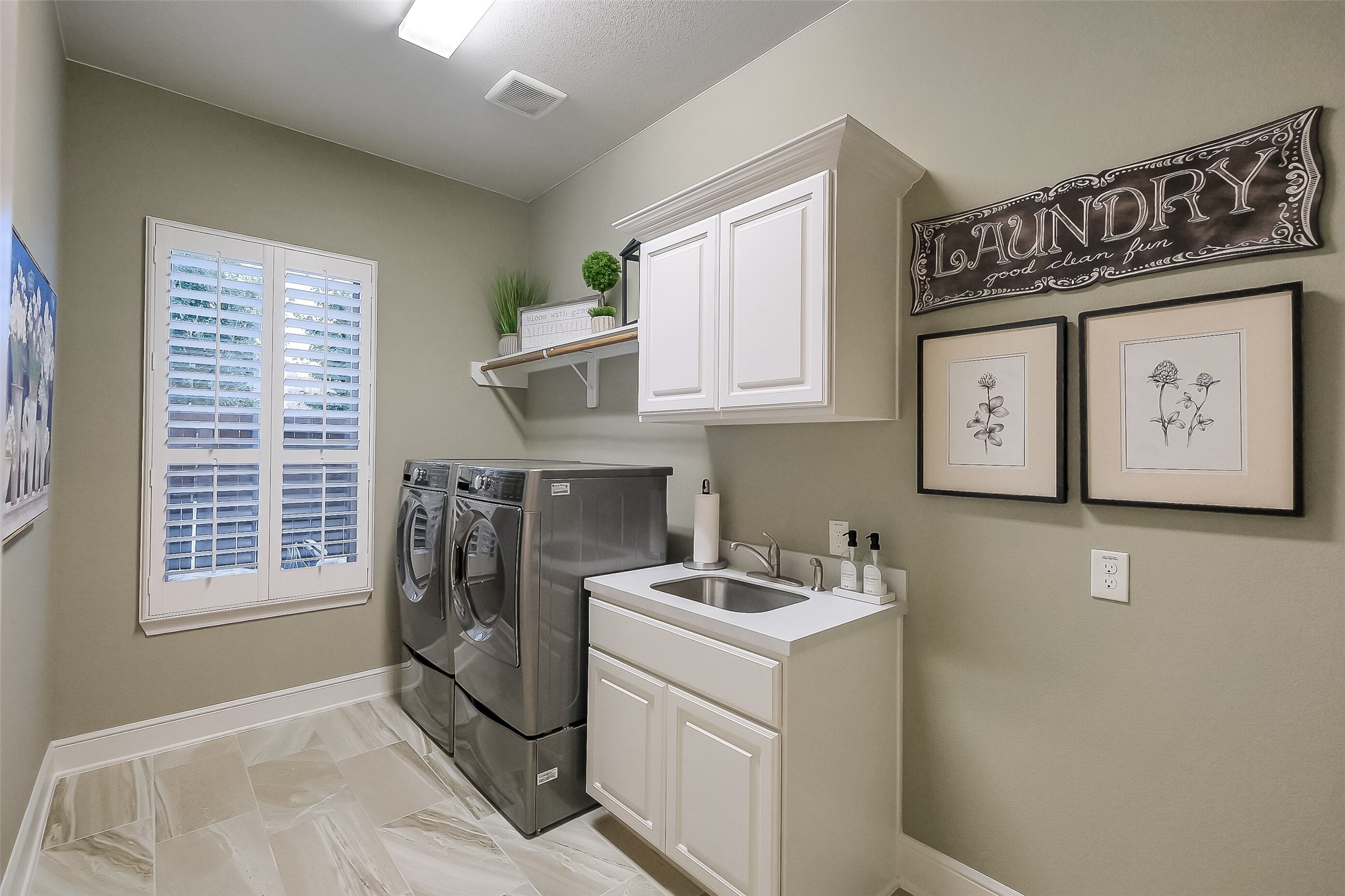 This oversized laundry room means there is plenty of room for your machines, a separate sink and cabinetry and room for a second refrigerator if desired.