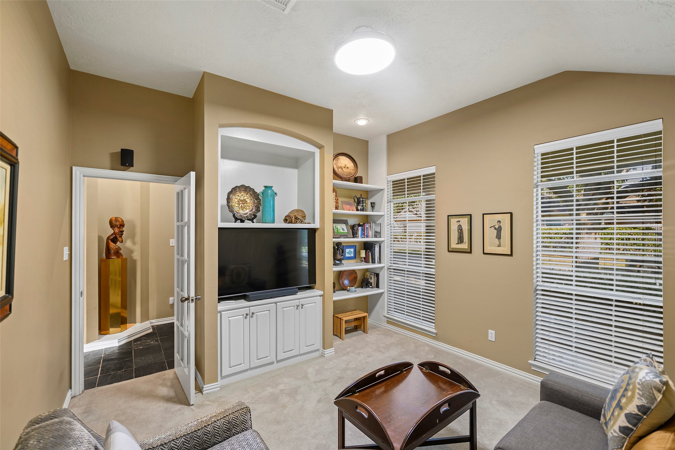 As you enter the home the first room to your left is the media room with built in shelfs.