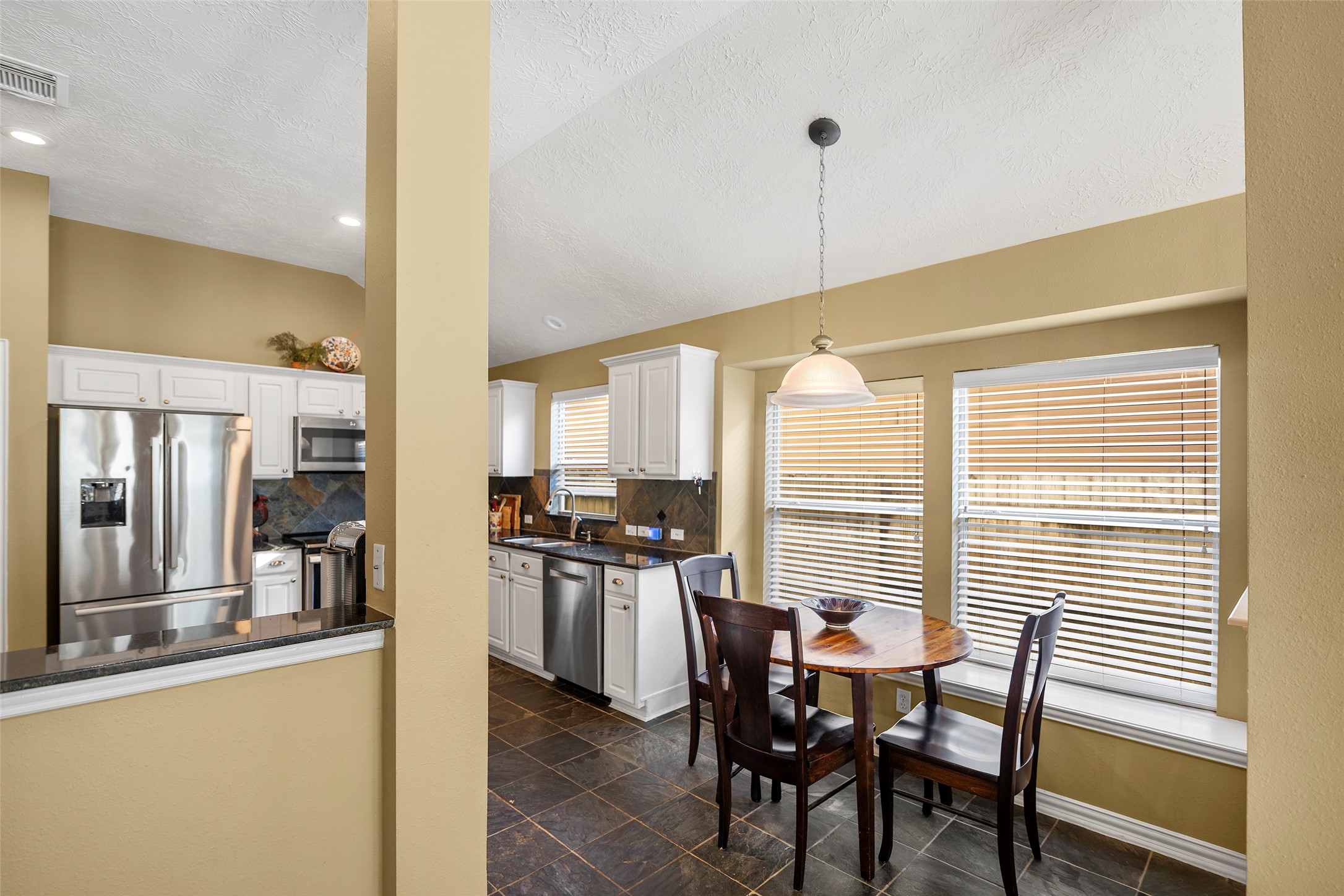 Eat in breakfast area overlooked by the natural light and also features a window bench.