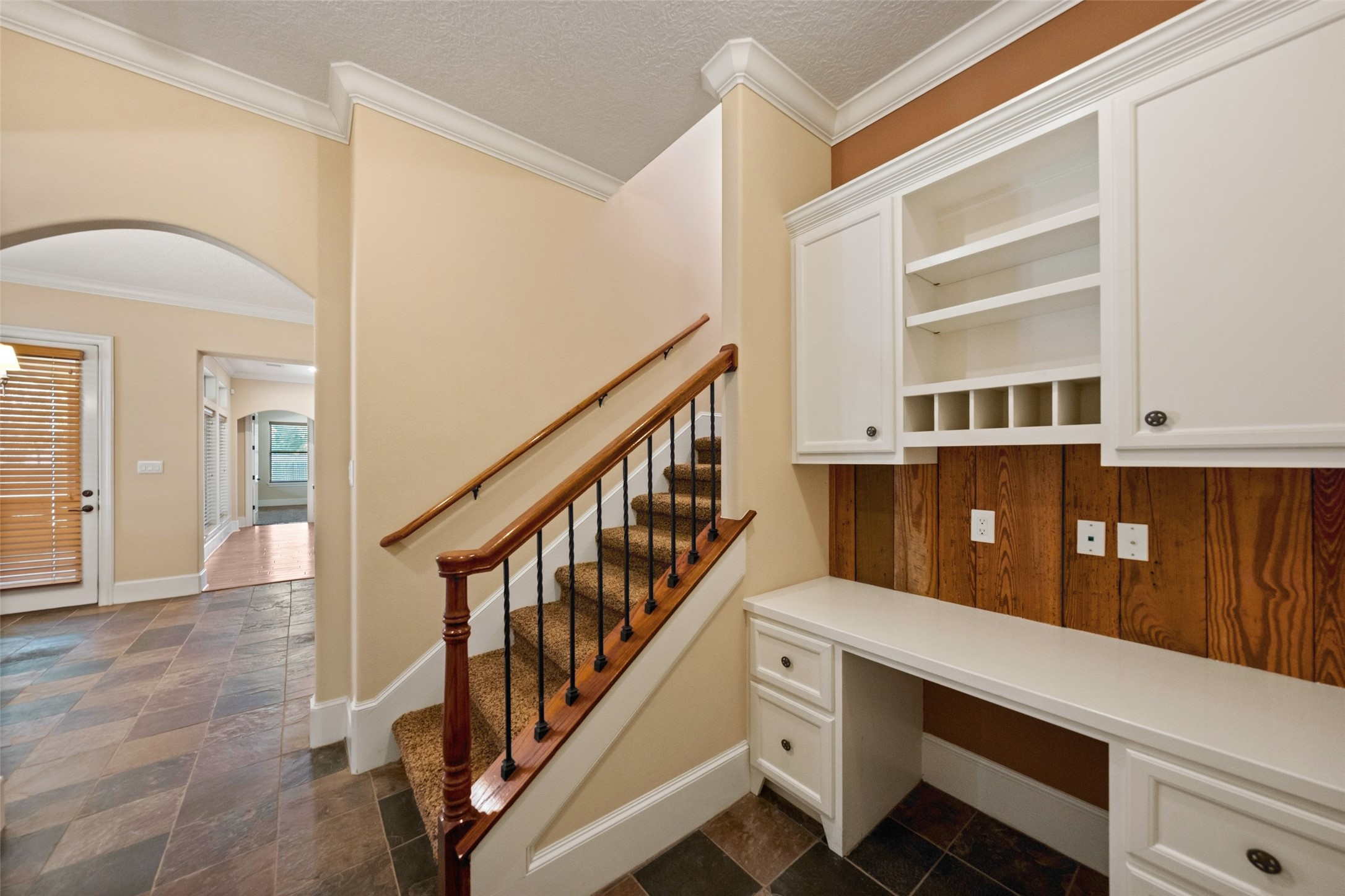 The utility room includes custom built-ins, a convenient back staircase, and a secure safe room.