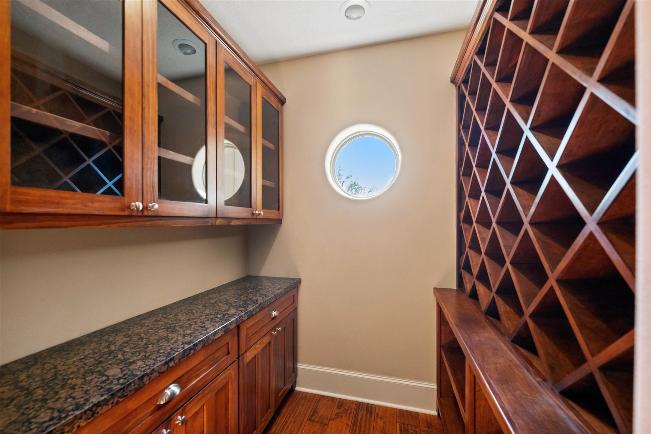 Elegant wine room with ample storage and stylish cabinetry.