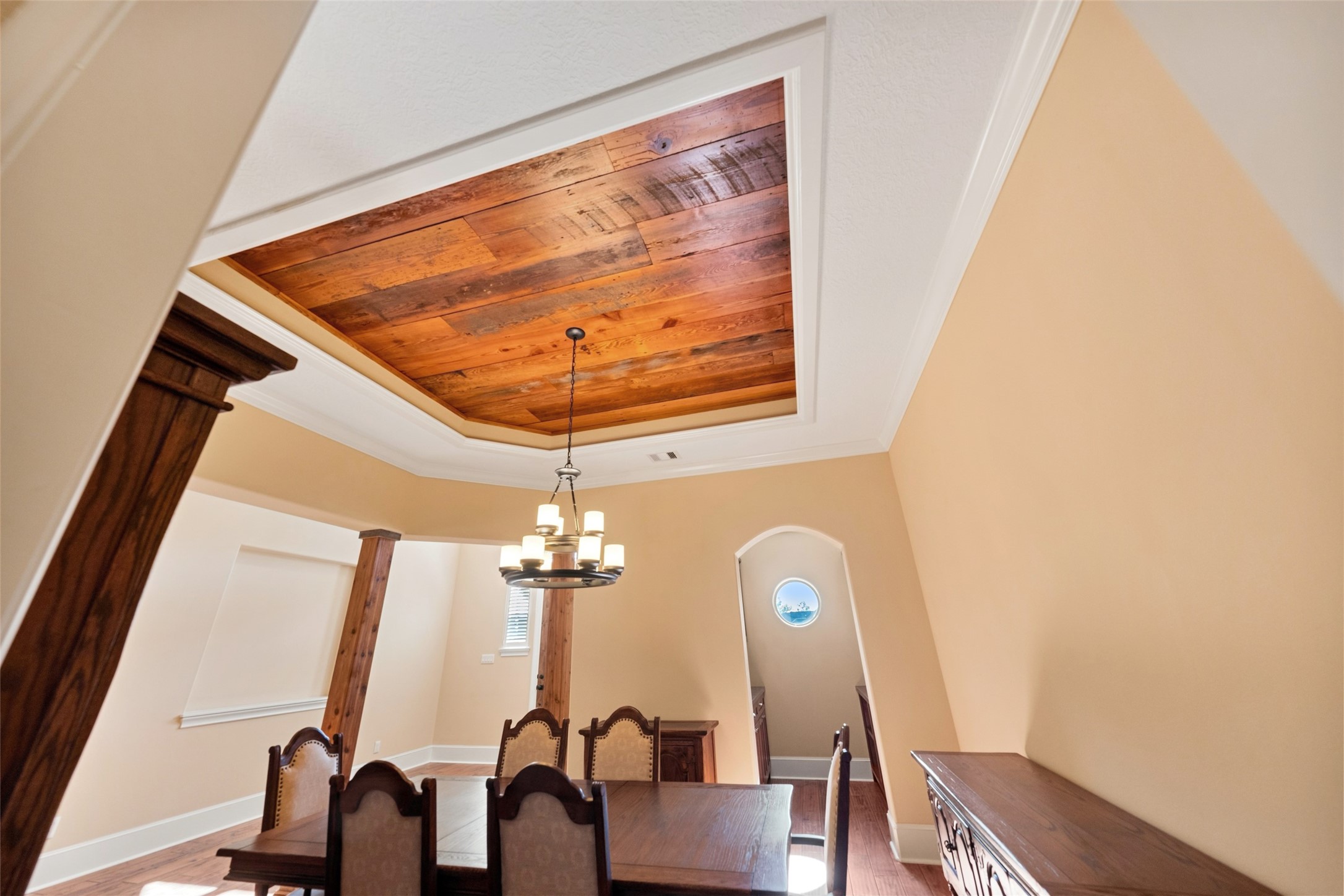 Elegant reclaimed barn wood coffered ceiling adds warmth and sophistication to the dining area.