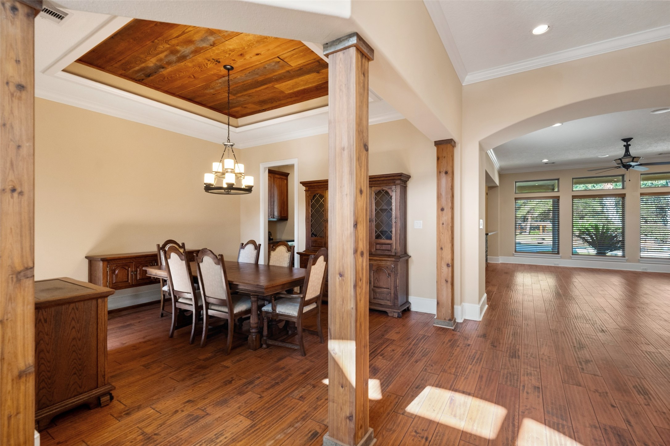 Spacious formal dining room with an elegant raised ceiling and a separate wine room for added convenience.