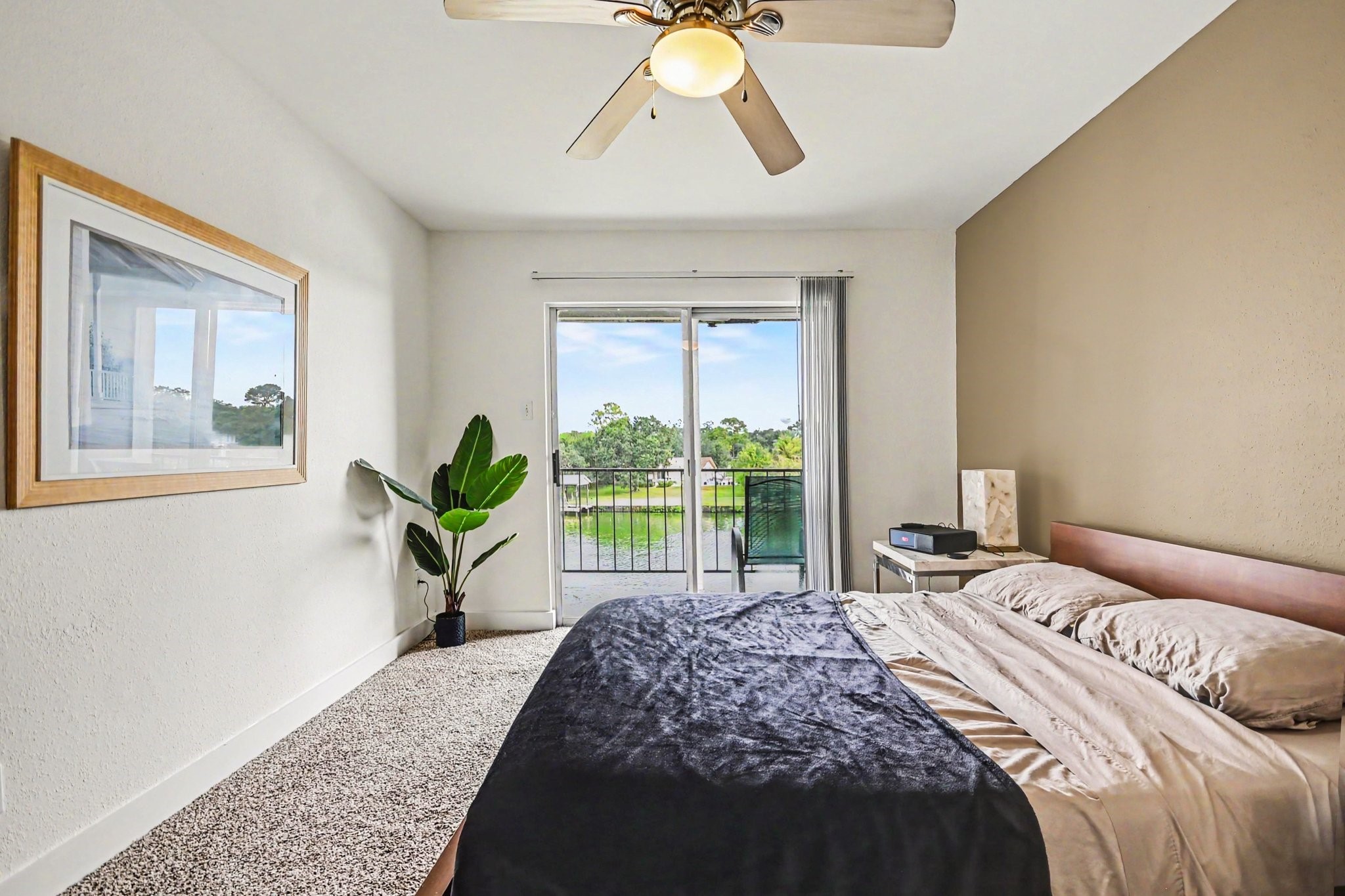 Primary bedroom with water view from the balcony