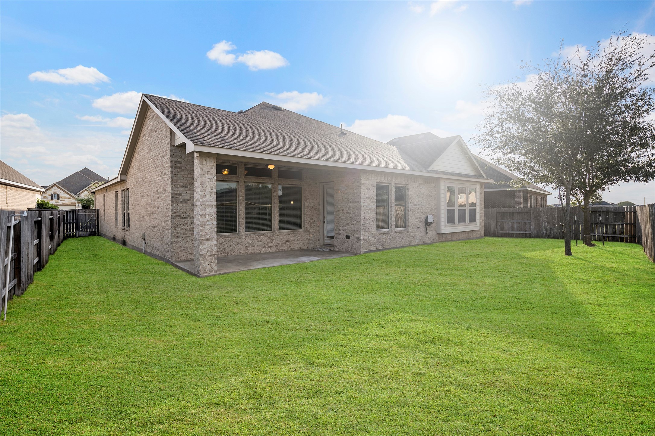 Charming brick home with a spacious backyard, perfect for outdoor activities and relaxation.