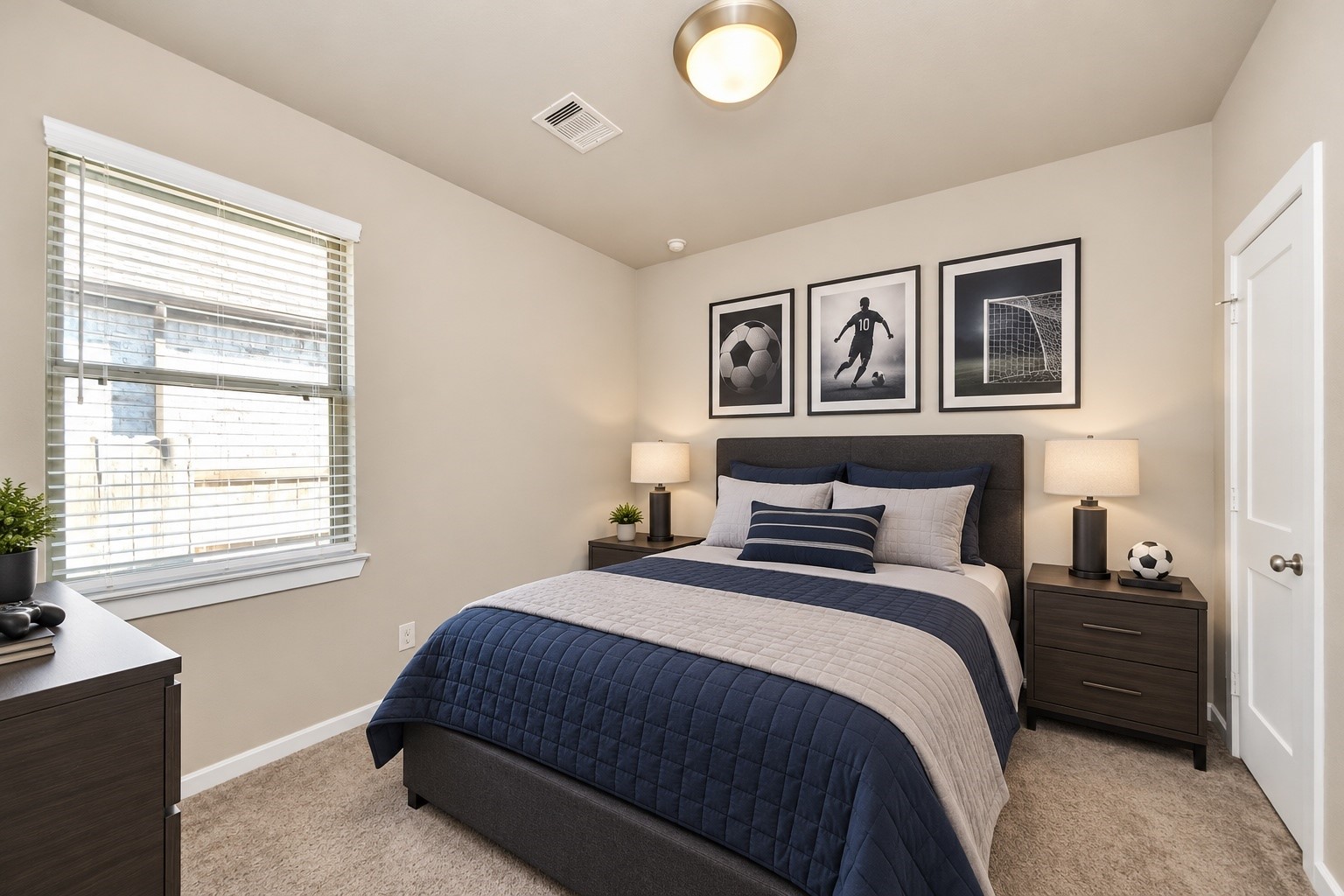 Comfortable secondary bedroom featuring neutral finishes, plush carpeting, and natural light.