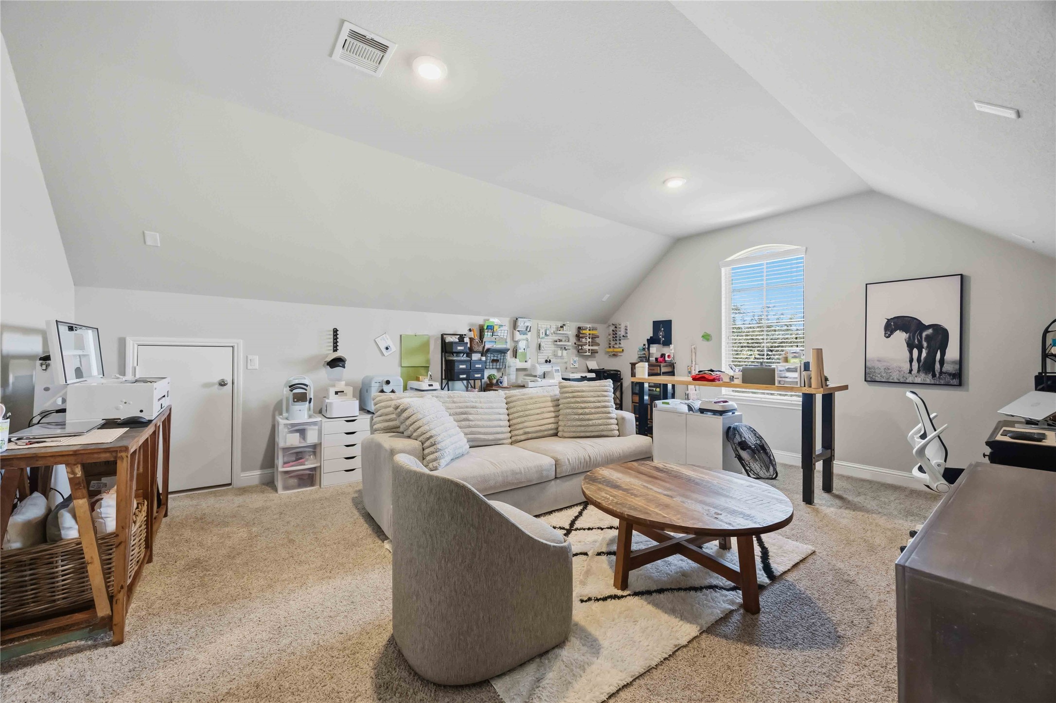 The upstairs media room is made for movie nights, game days, and lazy weekends.