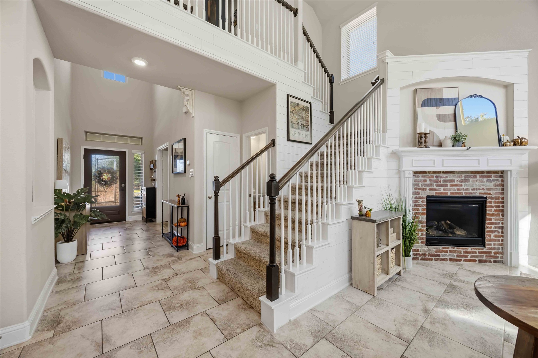 The full mosaic fireplace steals the show, a true showpiece beside the staircase.