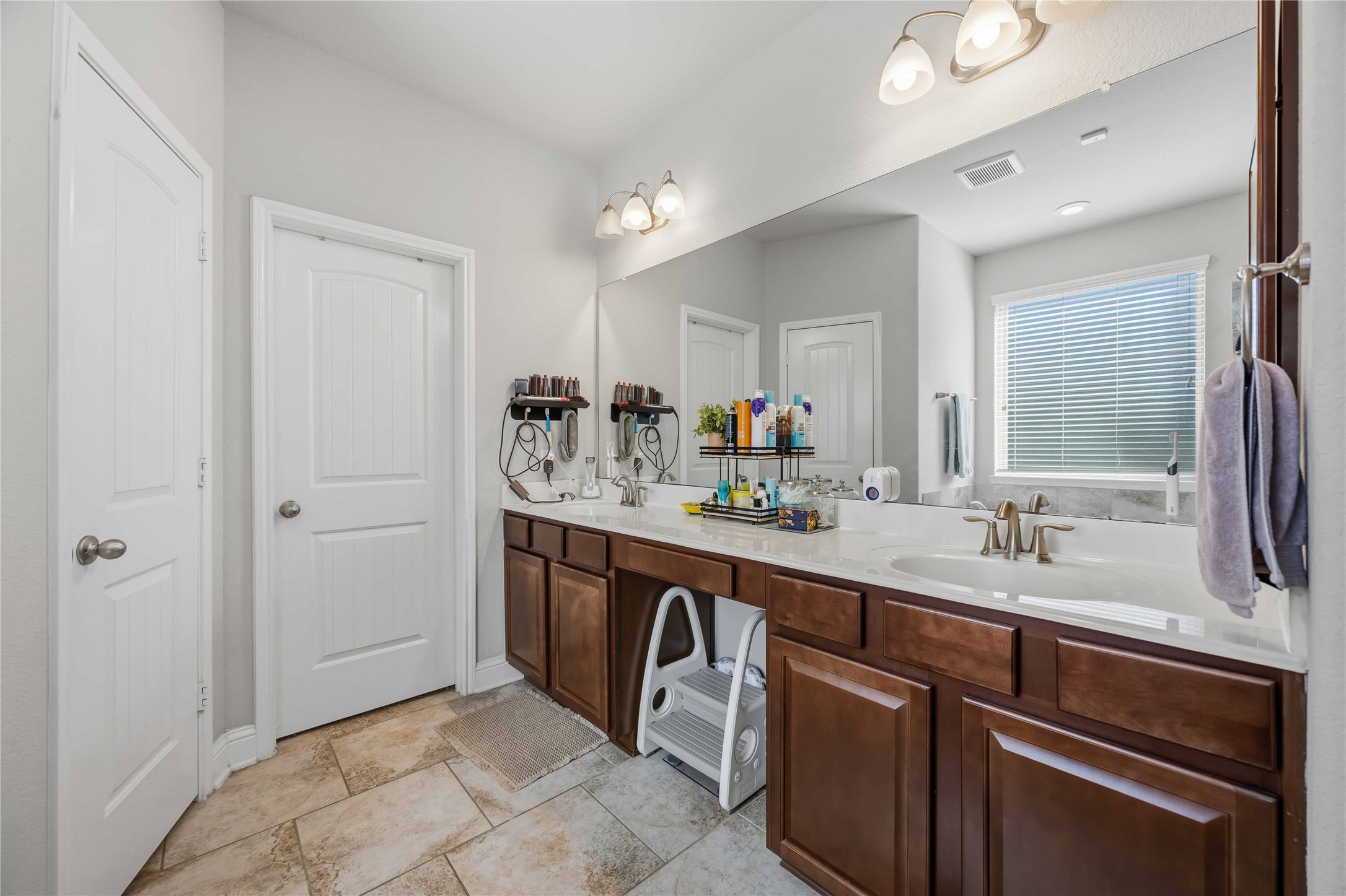 Double vanities with plenty of cabinet space make busy mornings run smoothly.
