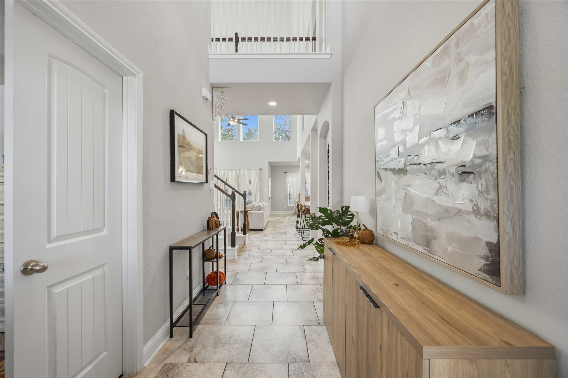Step inside and the bright foyer draws your eye straight up to soaring ceilings ahead.