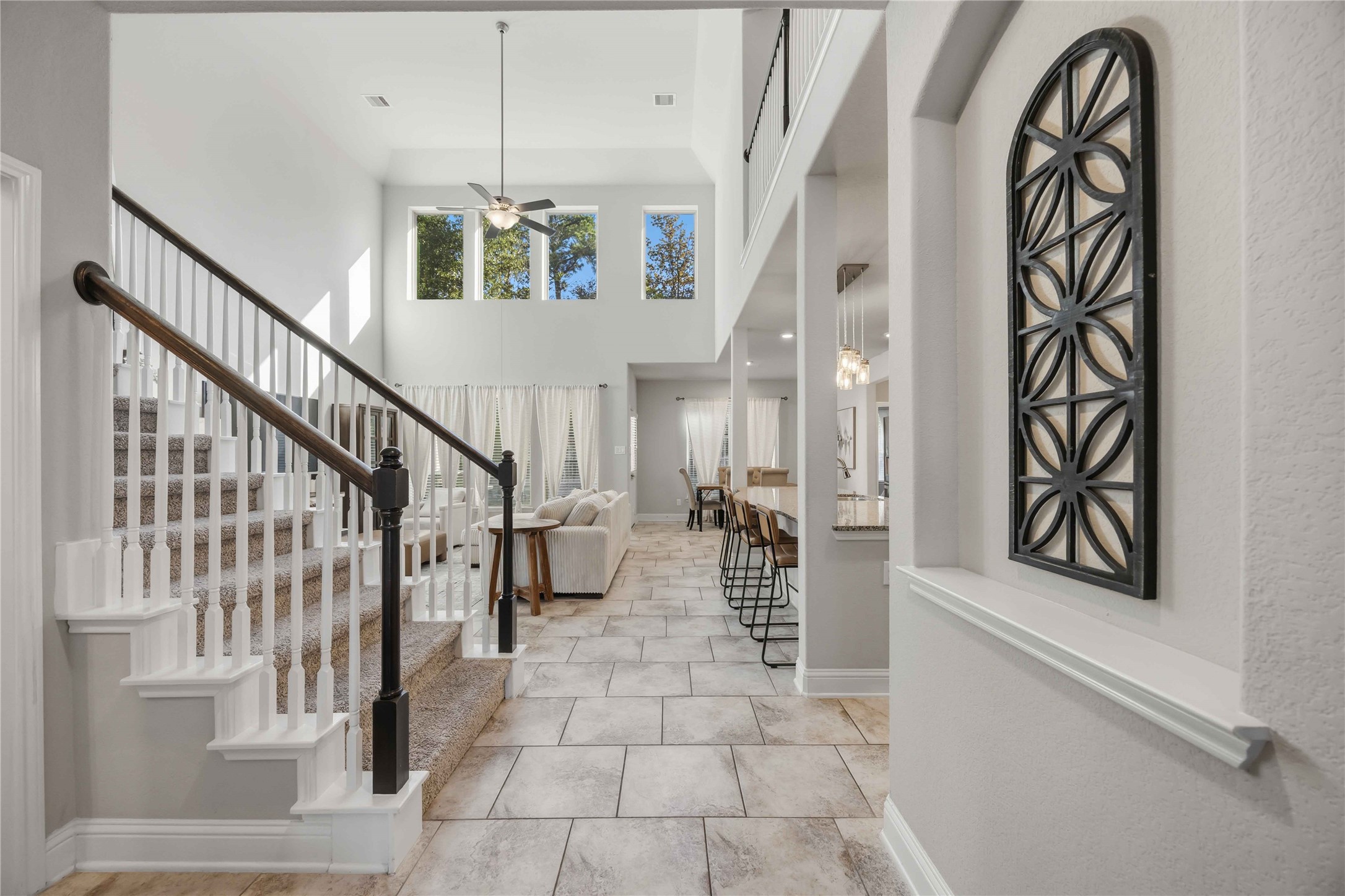 White balusters and a decorative iron accent give the staircase a touch of character.
