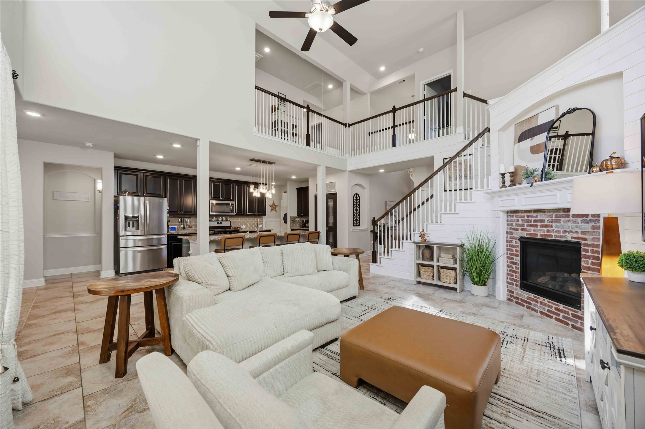 The heart of the home opens up, with living, kitchen, and the upstairs overlook all flowing together.