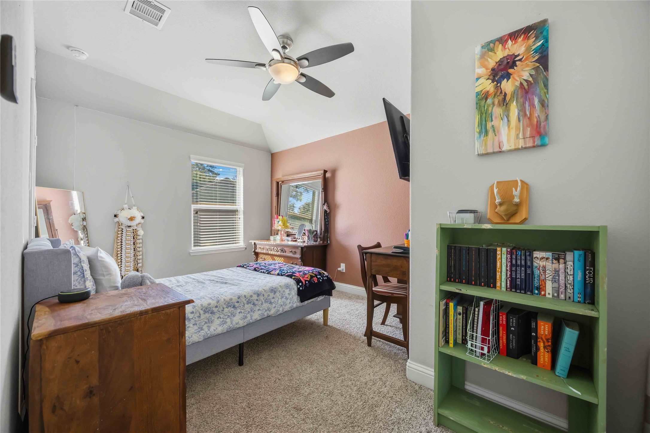 A sloped ceiling gives this light-filled bedroom a cozy, tucked-away feel.