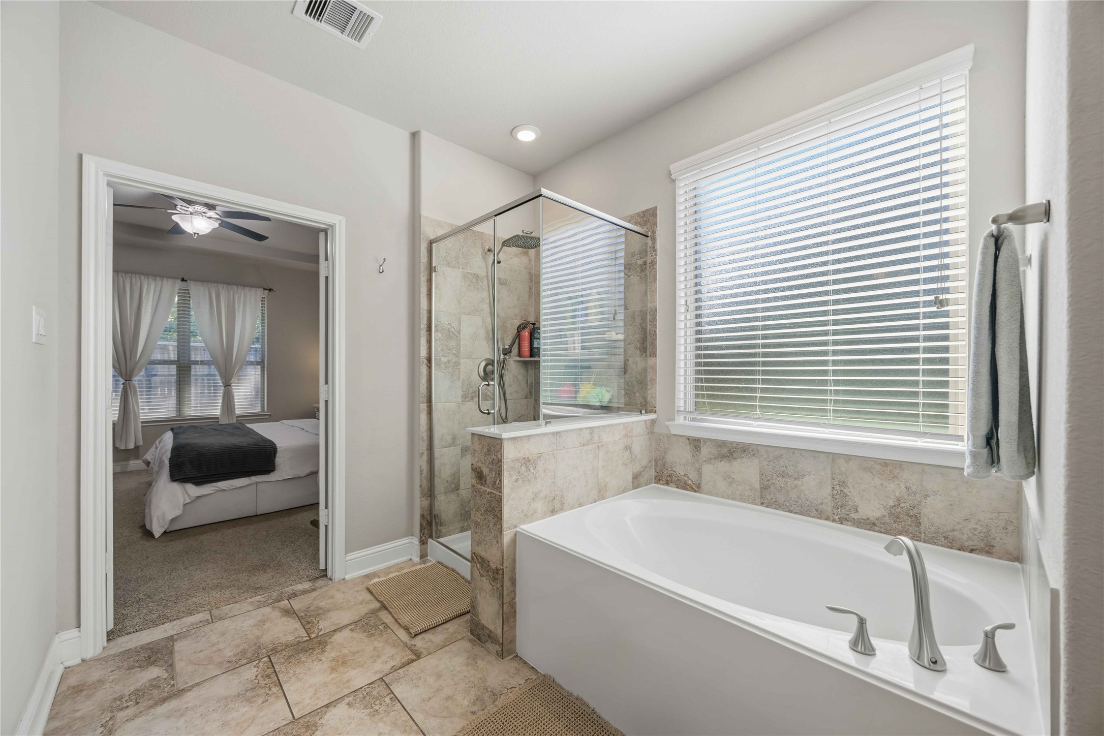 A soaking tub beneath the window sets the scene for slow, relaxing evenings.