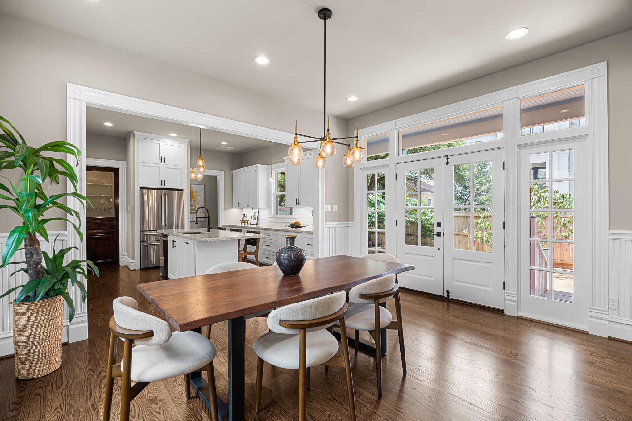 Notice the detail work and amount of natural light that comes from the double doors that lead to the side yard and balcony.