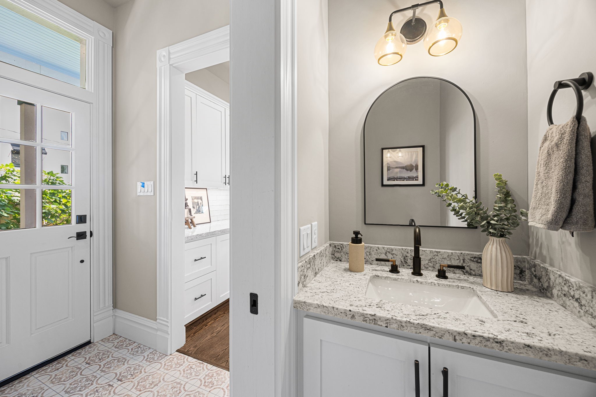 The downstairs powder bathroom offers a perfect escape away from others. The location by the back door makes this space practical for both guests as well as the eventual pool guests (once it's been added).