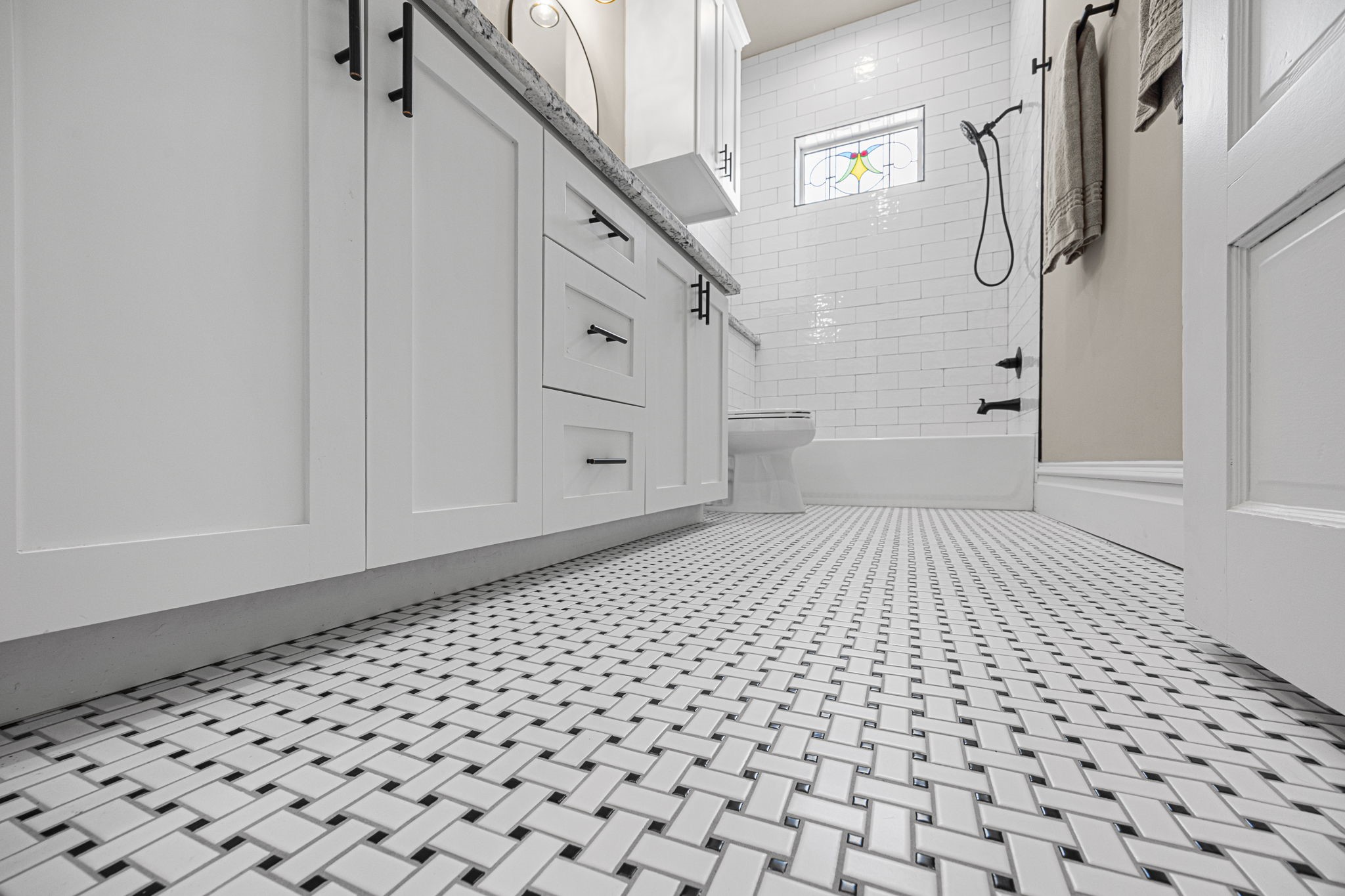The bathroom flooring adds a dose of vintage charm in this space.