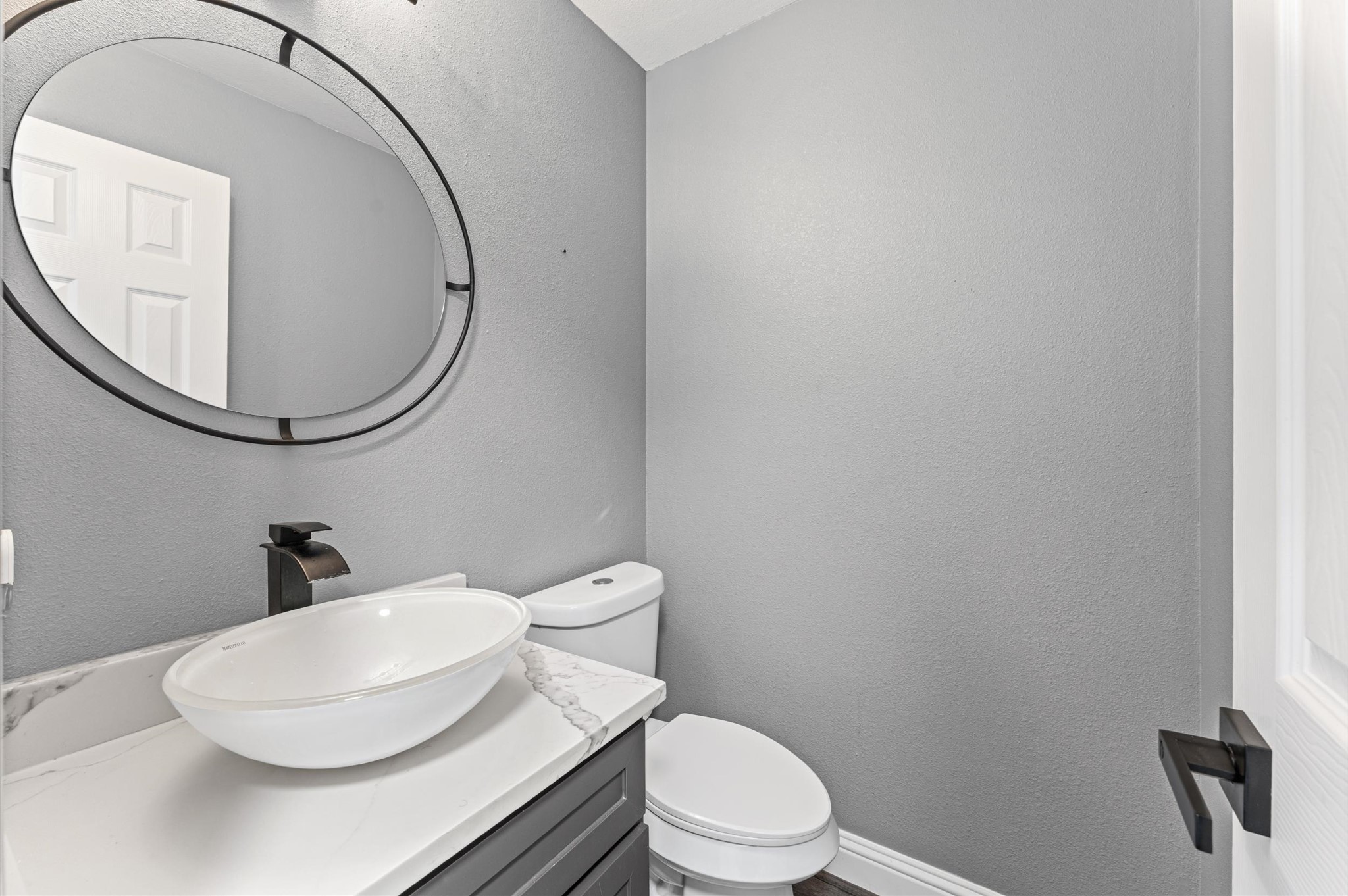 The first-floor half bath is conveniently located off the foyer.