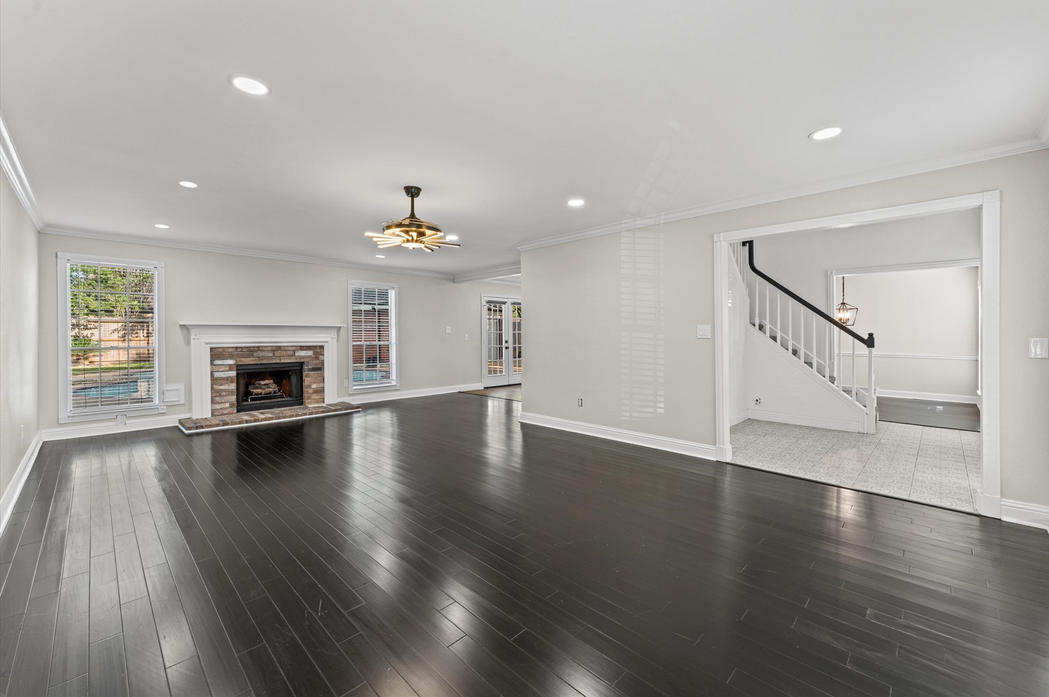 The first-floor Living Room features a wood-burning fireplace and windows overlooking the backyard pool. The first-floor Living Room features a wood-burning fireplace and windows overlooking the backyard pool.
