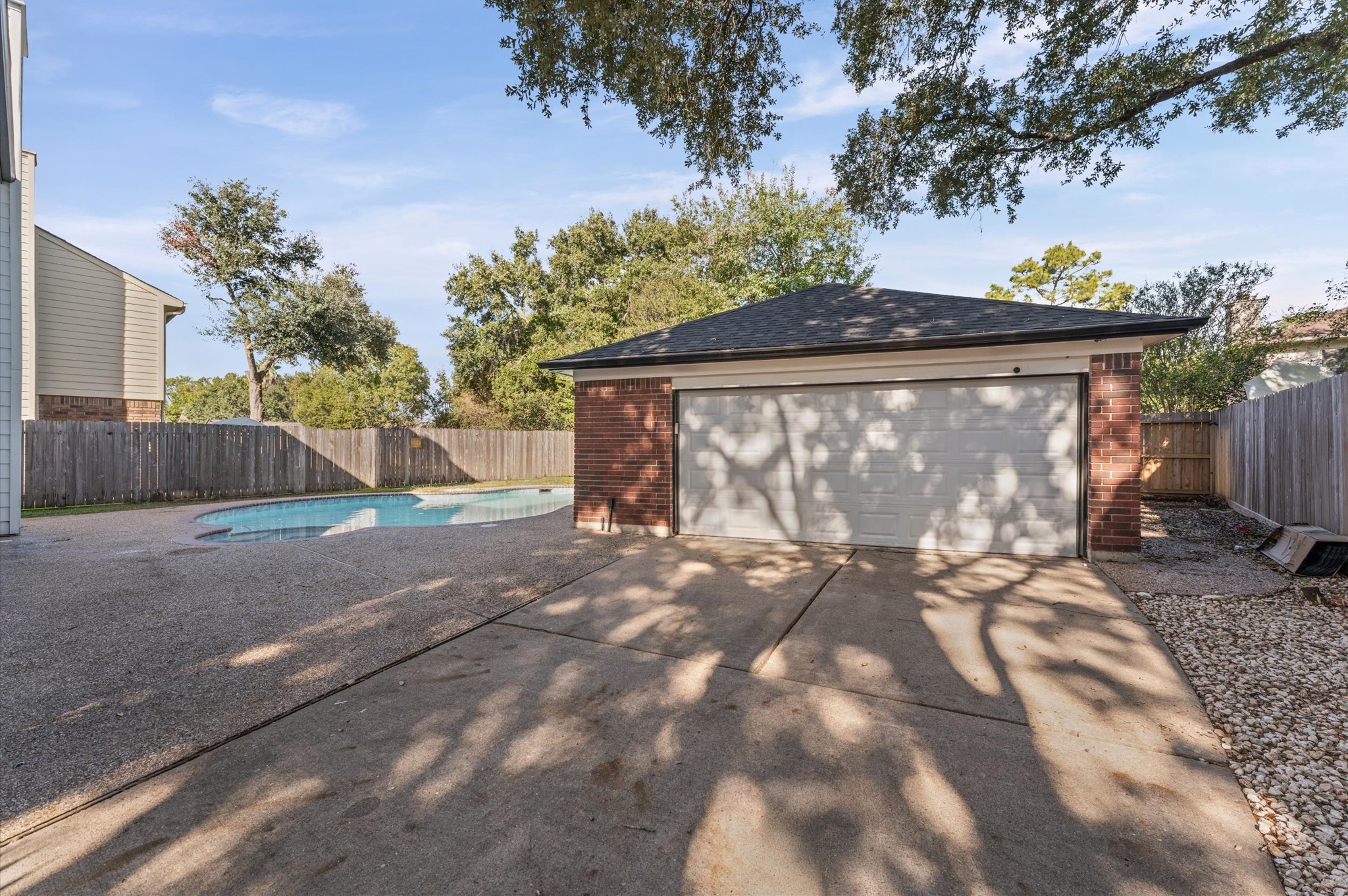 The detached two-car garage sits behind the home, beyond the gated driveway.