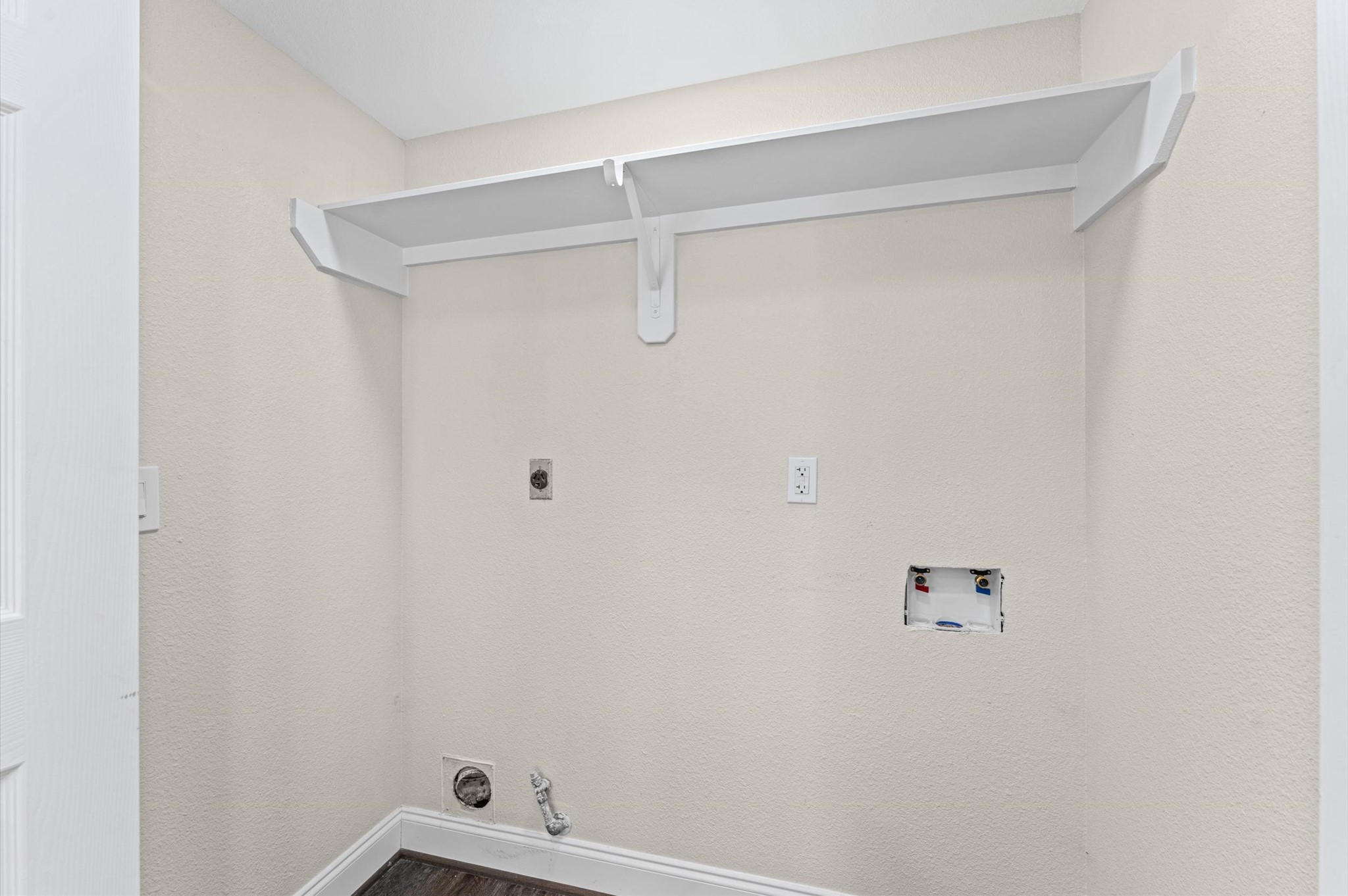 The laundry area is located on the first floor beside the kitchen.