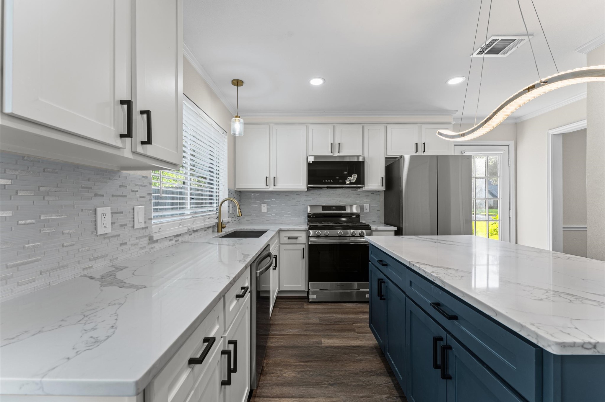 Kitchen features updated cabinetry, stainless steel appliances, and white quartz counterops. Kitchen features updated cabinetry, stainless steel appliances, and white quartz counterops.