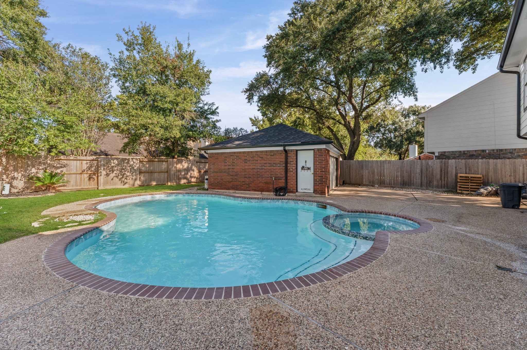 The backyard features an inground swimming pool and spa, with mature trees and space to relax outdoors. The backyard features an inground swimming pool and spa, with mature trees and space to relax outdoors.