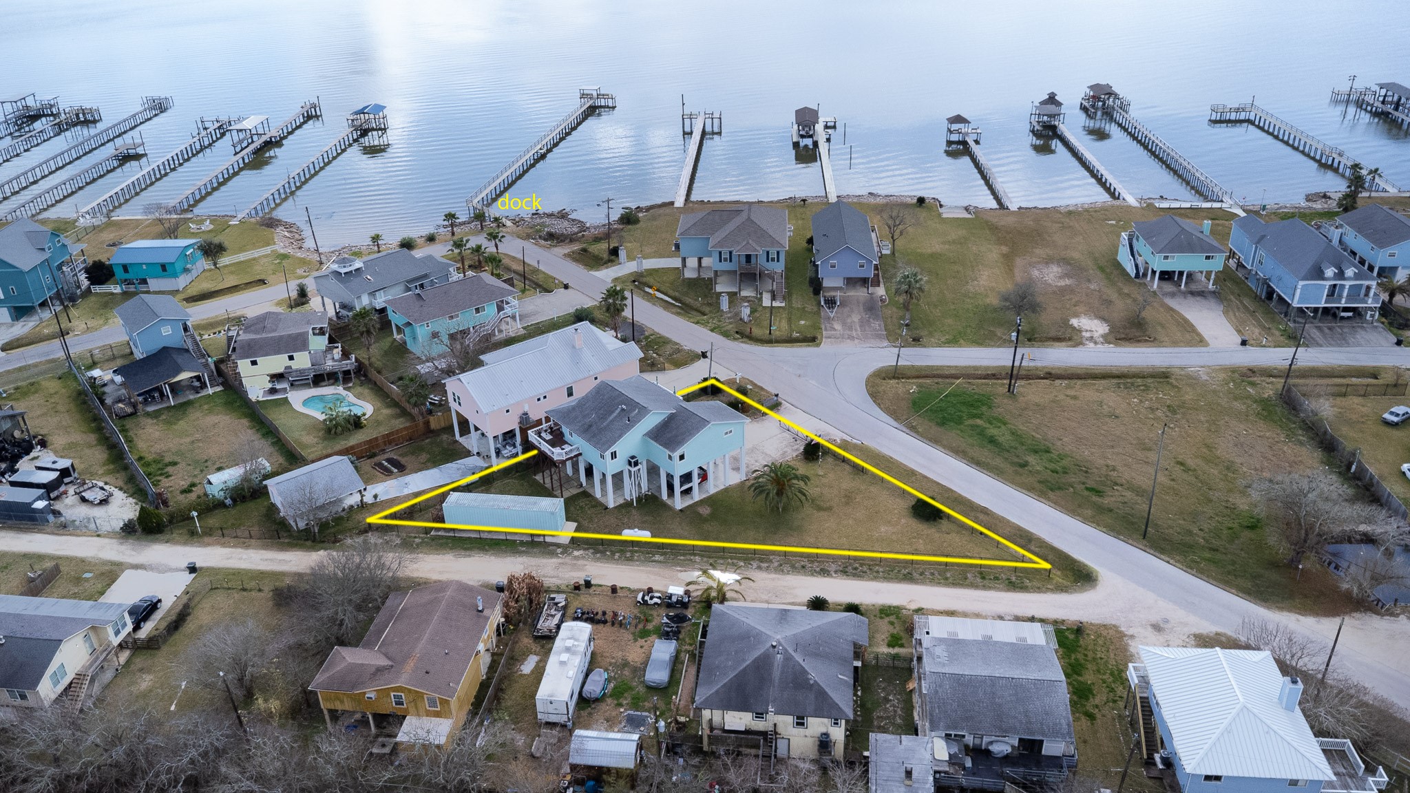 Pie shaped corner lot with private bay access from the pier that only 5 properties share.