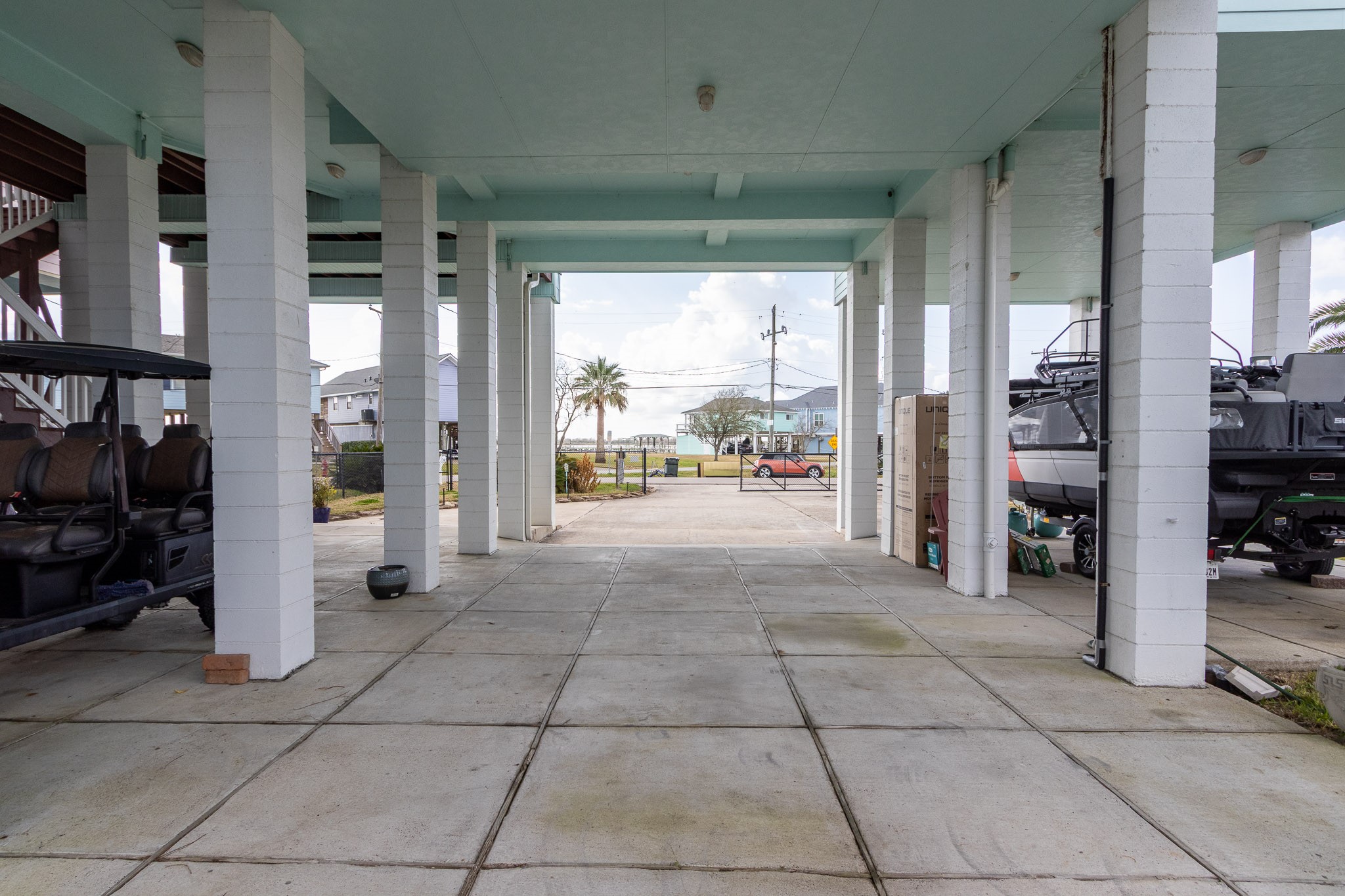 Tall concrete pillars-- ready for your boat, golf cart. Plenty of parking and additional entertaining space.
