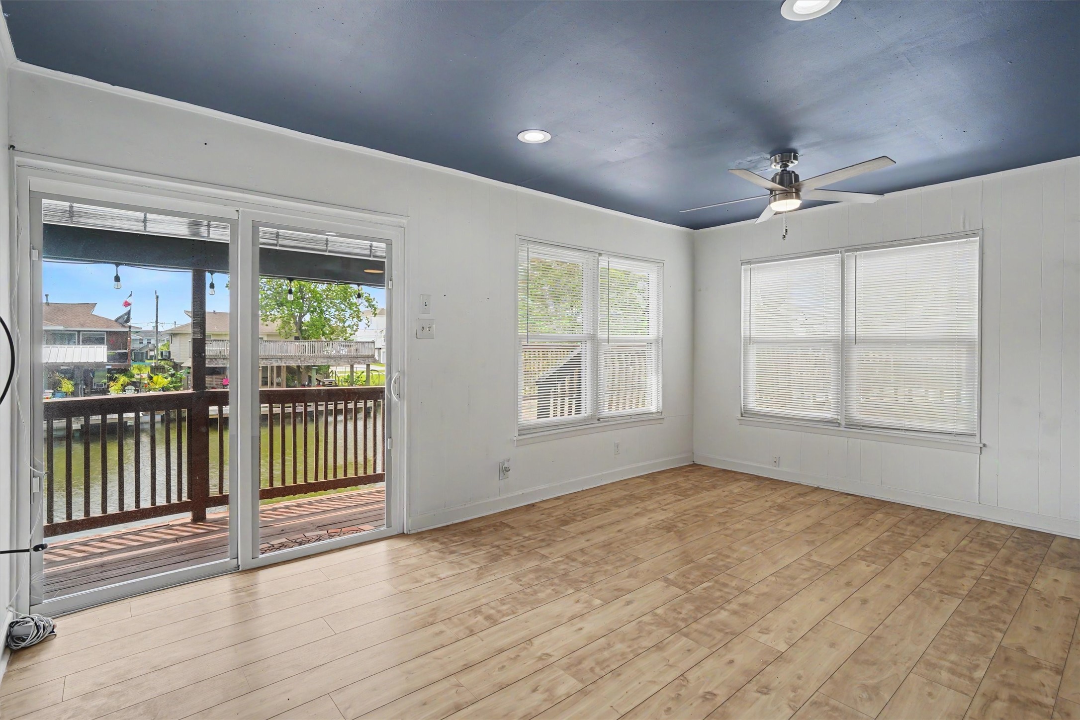 The living area is large and has room for a small dining table. Notice the updated windows allowing the natural sunlight and water views