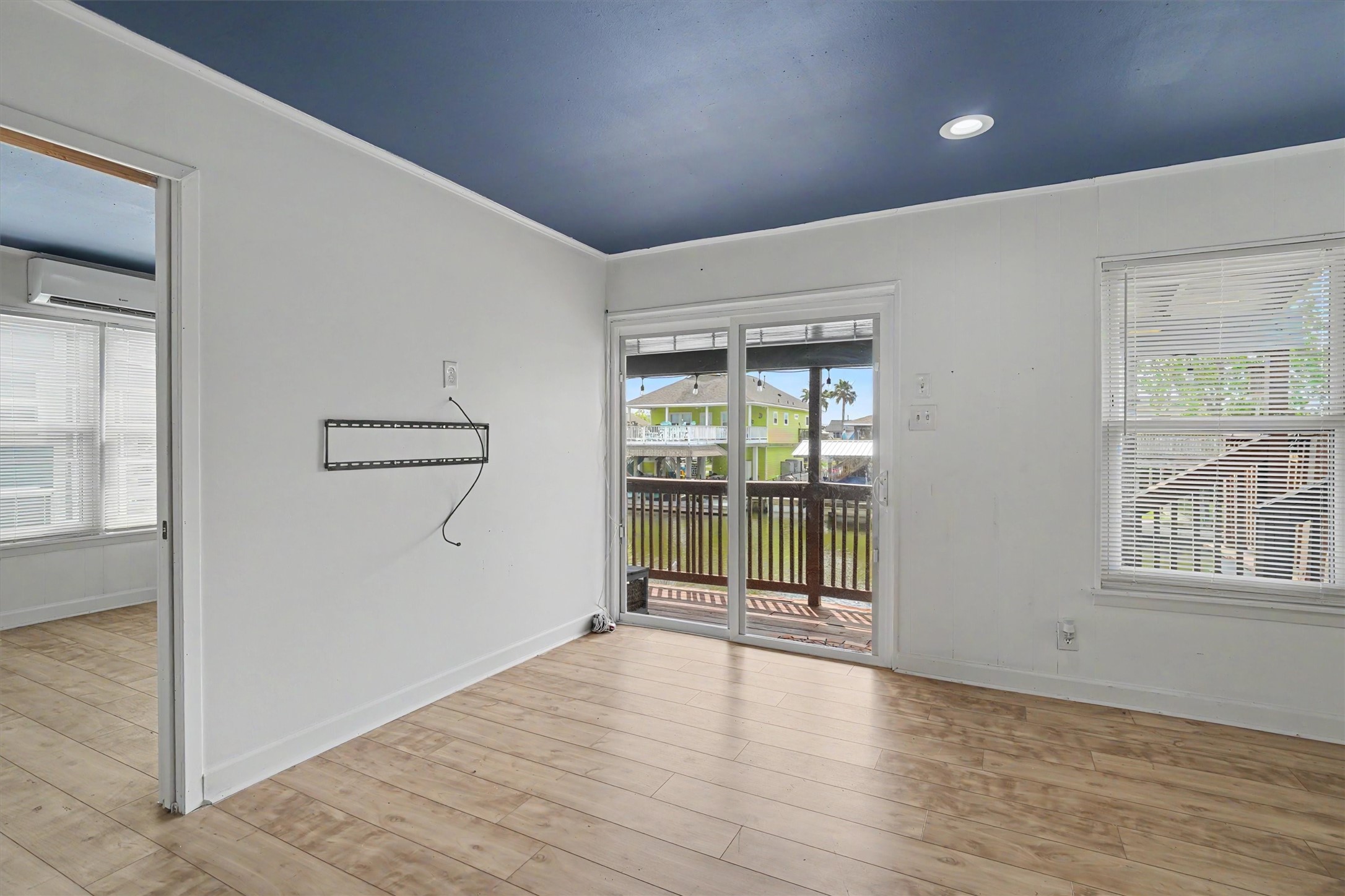 Sliding door on the water side of the home give maximum views of the water. The updated flooring is a stylish neutral tone