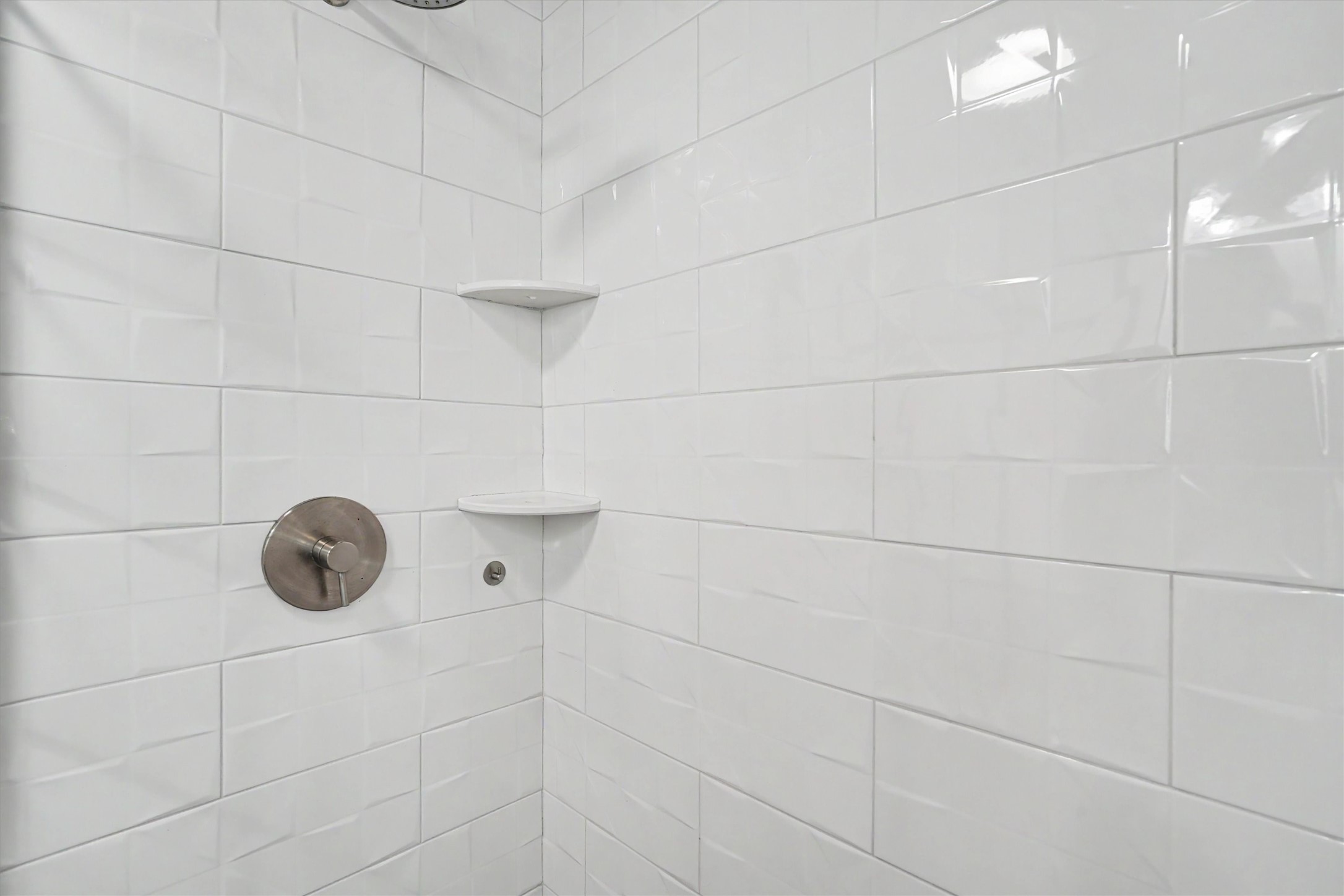 Updated oversized walk in shower with beveled tiles