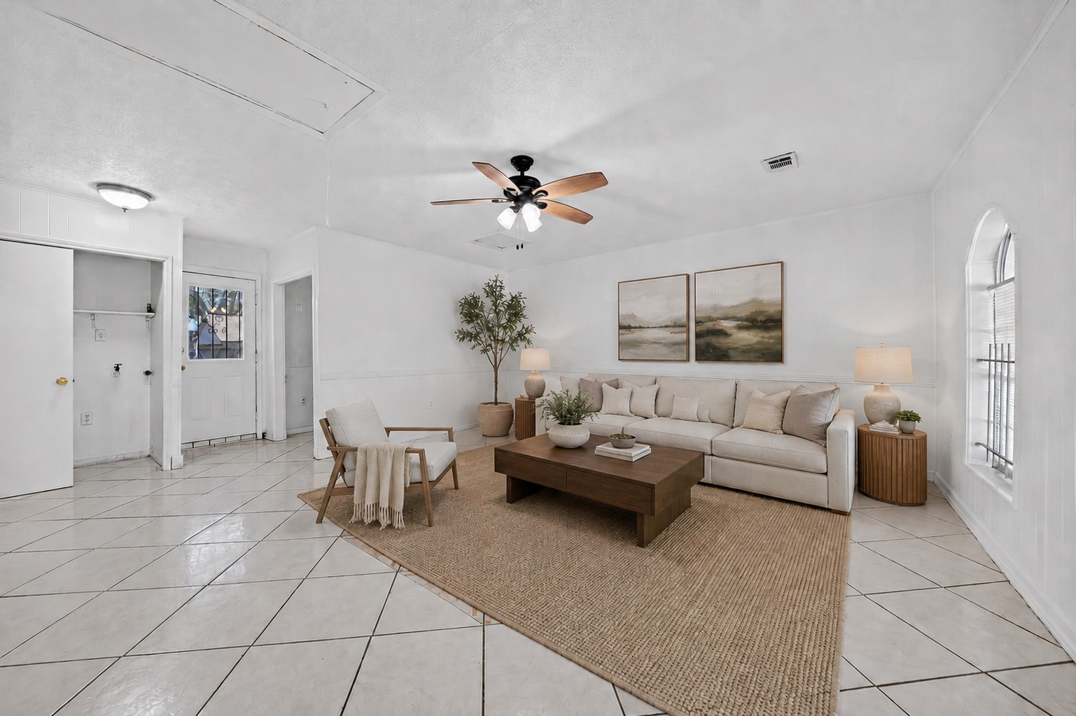 Spacious living area with abundant natural light and classic comfort.