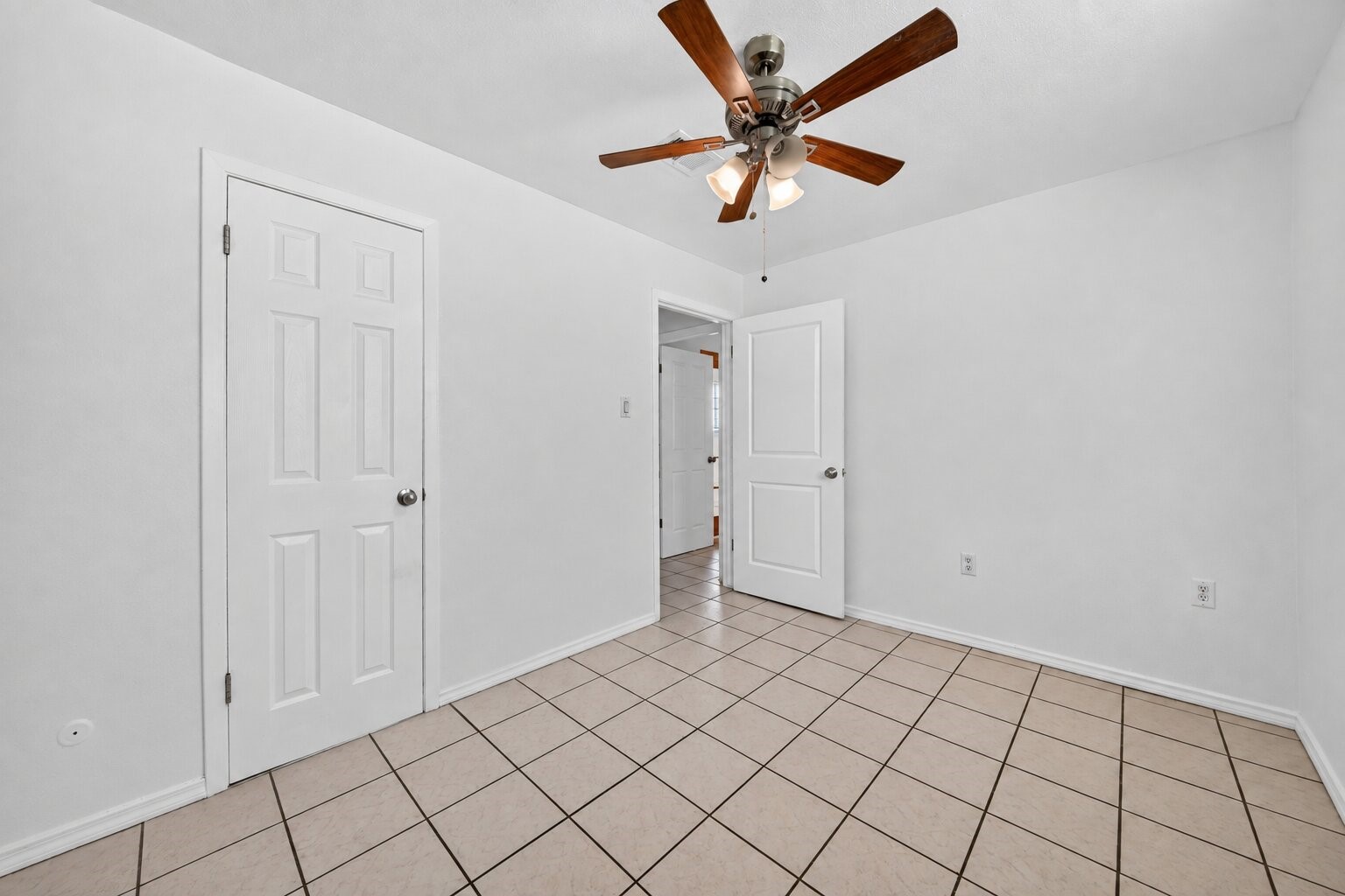 Versatile bedroom with generous closet space and natural light.