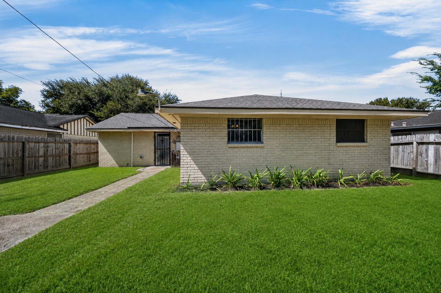 Well-maintained rear exterior overlooking a spacious green lawn.
