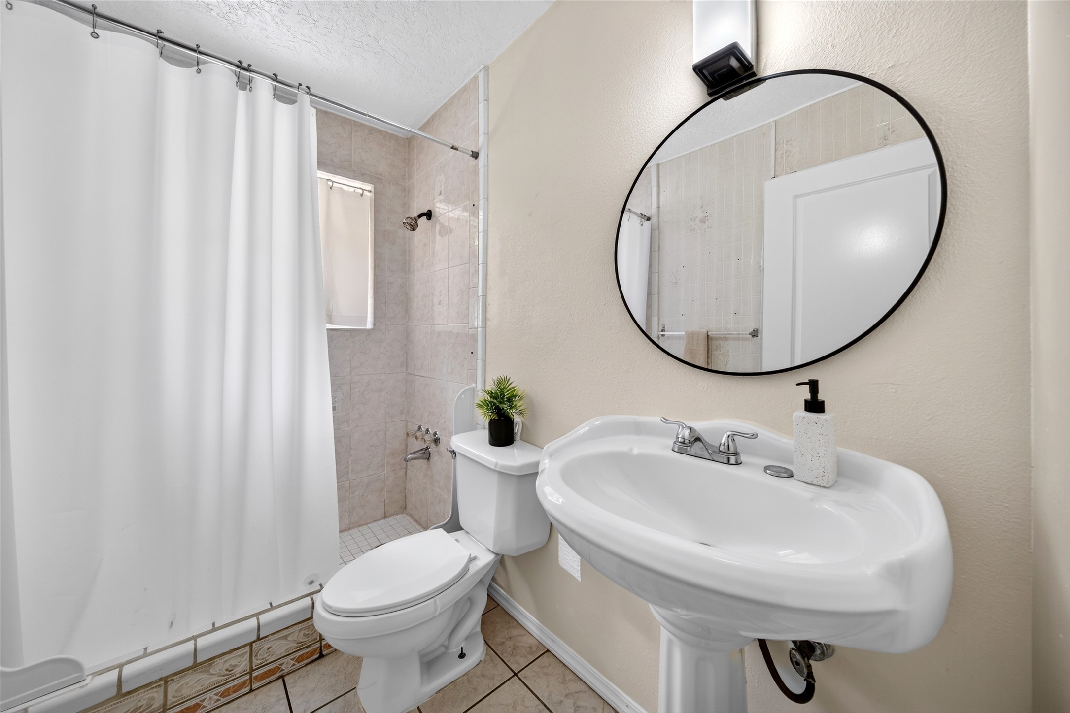 Bright secondary bath with a charming vanity and classic details.