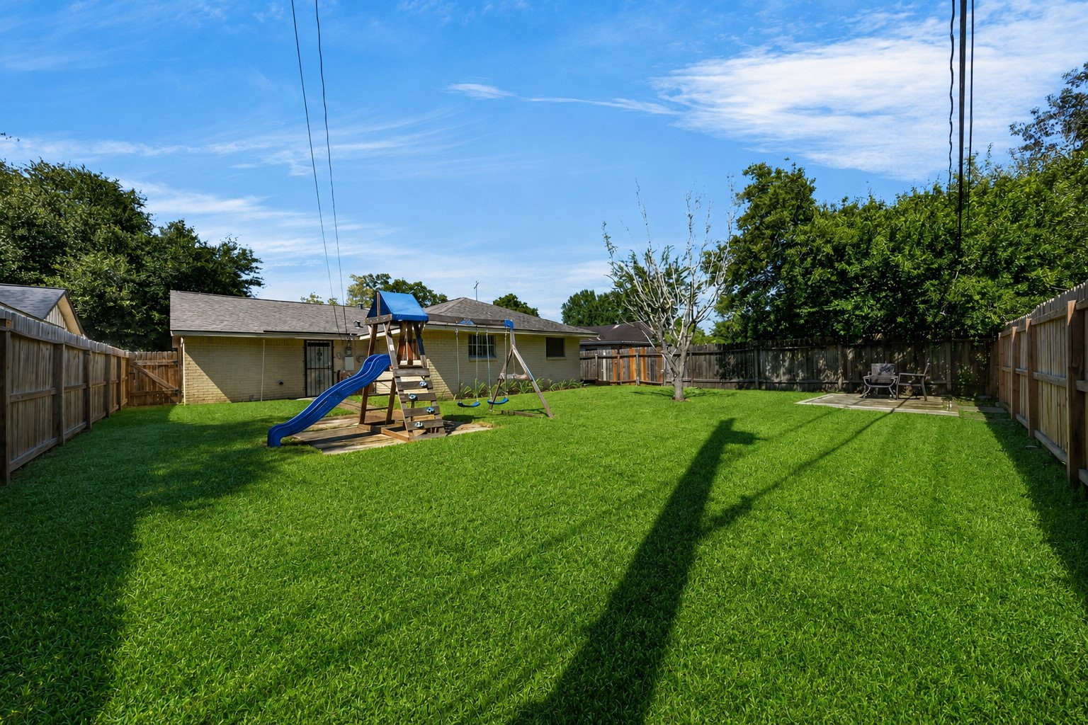 Expansive backyard with lush lawn and room for outdoor enjoyment.