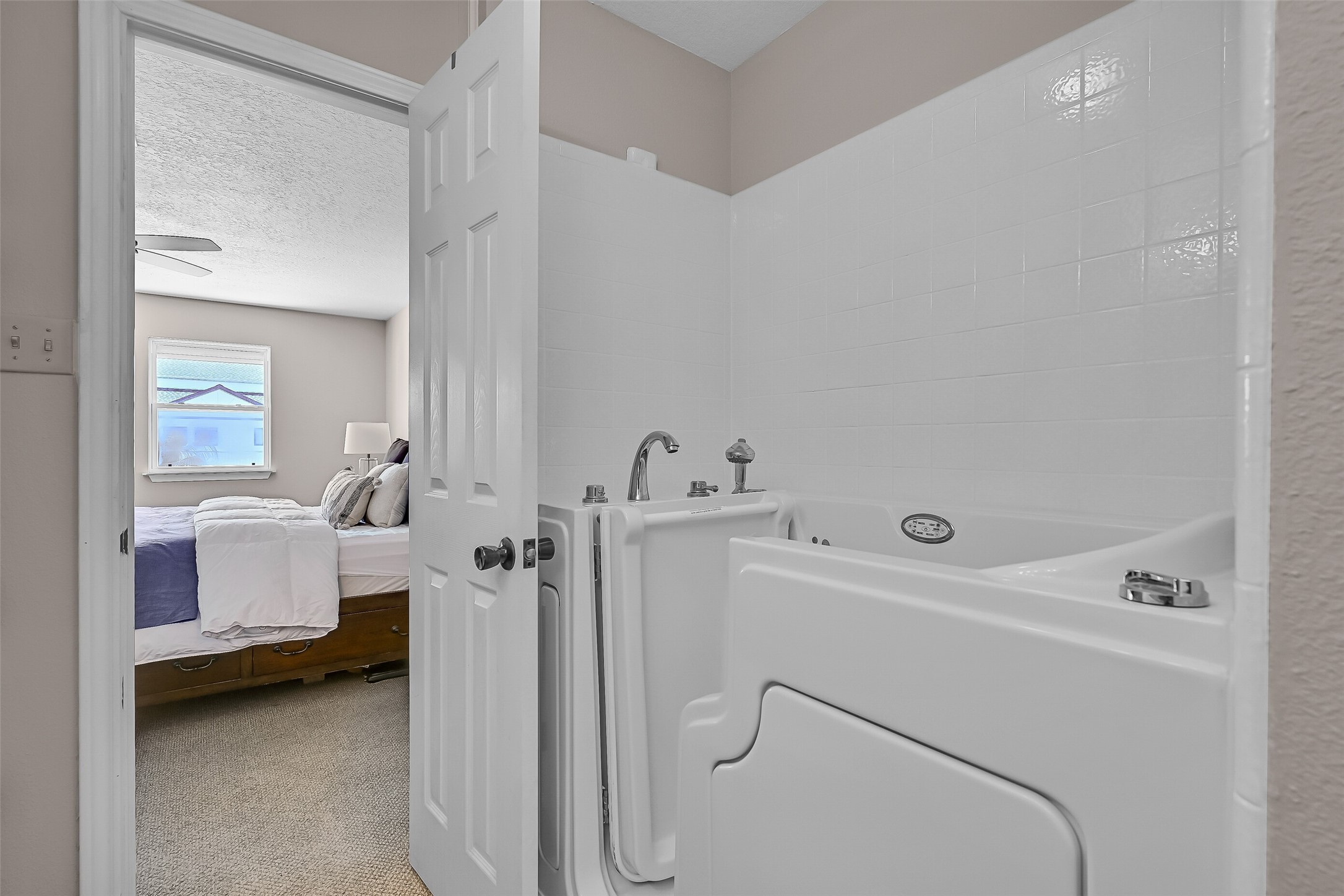 Designed with accessibility in mind, the primary bath includes a walk-in soaking tub and additional storage. Its location directly off the primary suite offers convenience while keeping all essential living spaces together on the main level.
