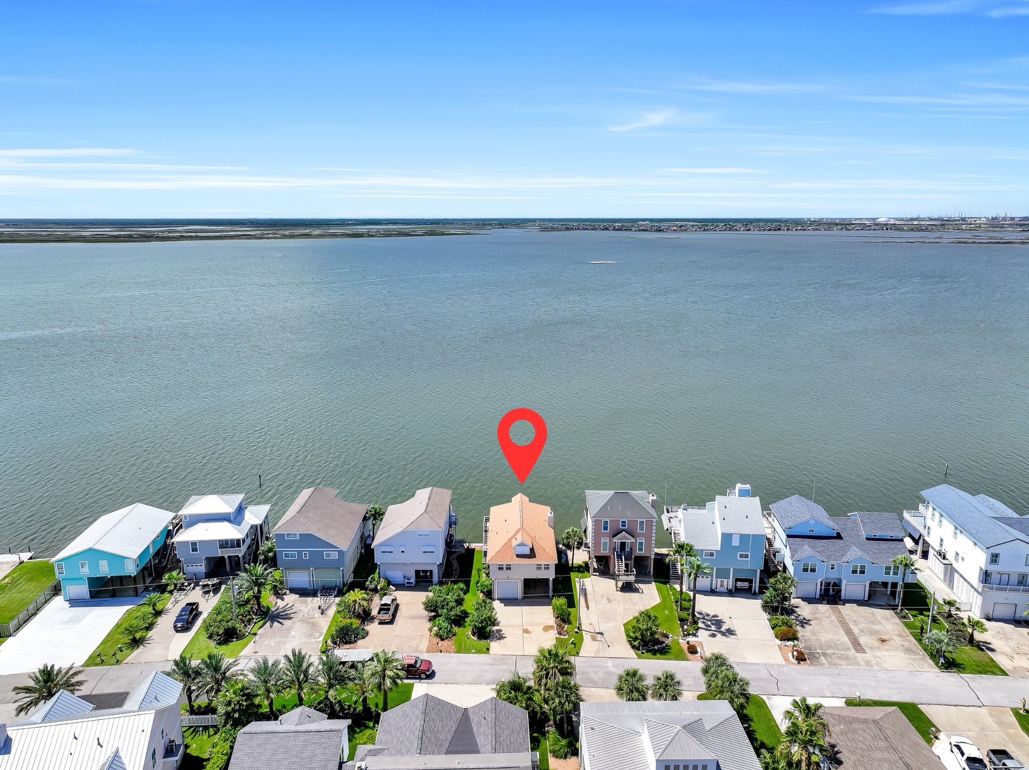 Perfectly positioned along the shoreline of Jones Bay, this waterfront home enjoys an exceptional location with sweeping open-water views and immediate access to West Bay beyond. From sunrise reflections on the water to spectacular west-facing sunsets, the setting is truly one of Tiki Island's greatest luxuries.