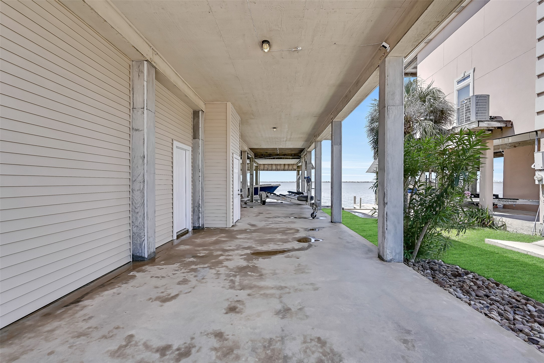 The ground level offers extensive covered space beneath the home, providing room for parking, storage, outdoor gear, and easy access to the waterfront. Whether you're unloading fishing equipment, rinsing off after a day on the bay, or preparing for a sunset cruise, this versatile space is designed for the coastal lifestyle.