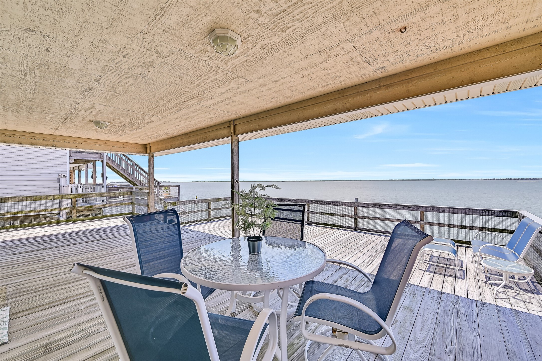 Step outside to an expansive covered deck overlooking Jones Bay, where cooling coastal breezes and panoramic water views create the perfect backdrop for morning coffee, afternoon relaxation, and unforgettable sunsets. With a coveted west-facing orientation, this outdoor retreat delivers front-row seats to the vibrant evening skies that make Tiki Island living so special.