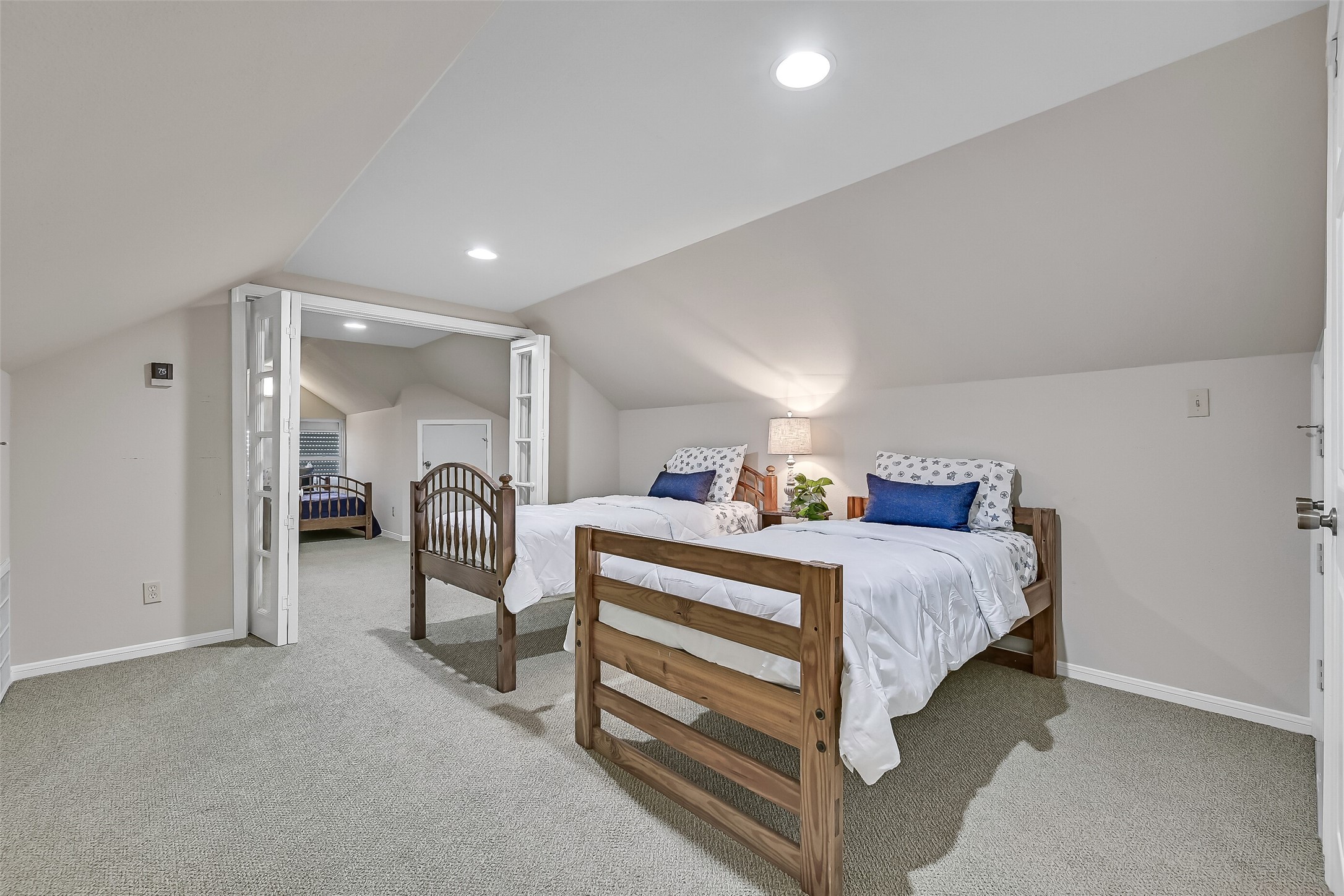 French doors connect two large flex rooms, creating a flexible layout ideal for guests, multi-generational living, hobbies, or a combination of sleeping and recreation space. The generous square footage allows this level to function however your lifestyle demands.