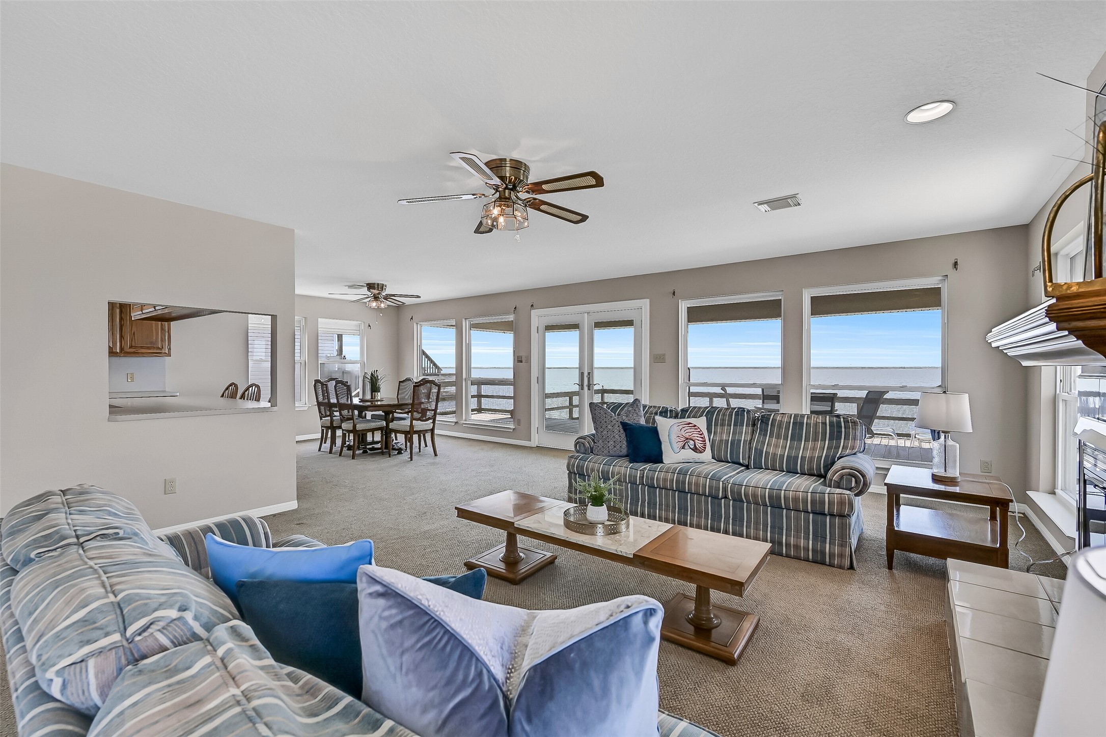 Designed for entertaining, the open-concept layout flows effortlessly between the living and dining spaces while showcasing spectacular water views from nearly every angle. Large windows fill the room with natural light and capture the beauty of the bay beyond.