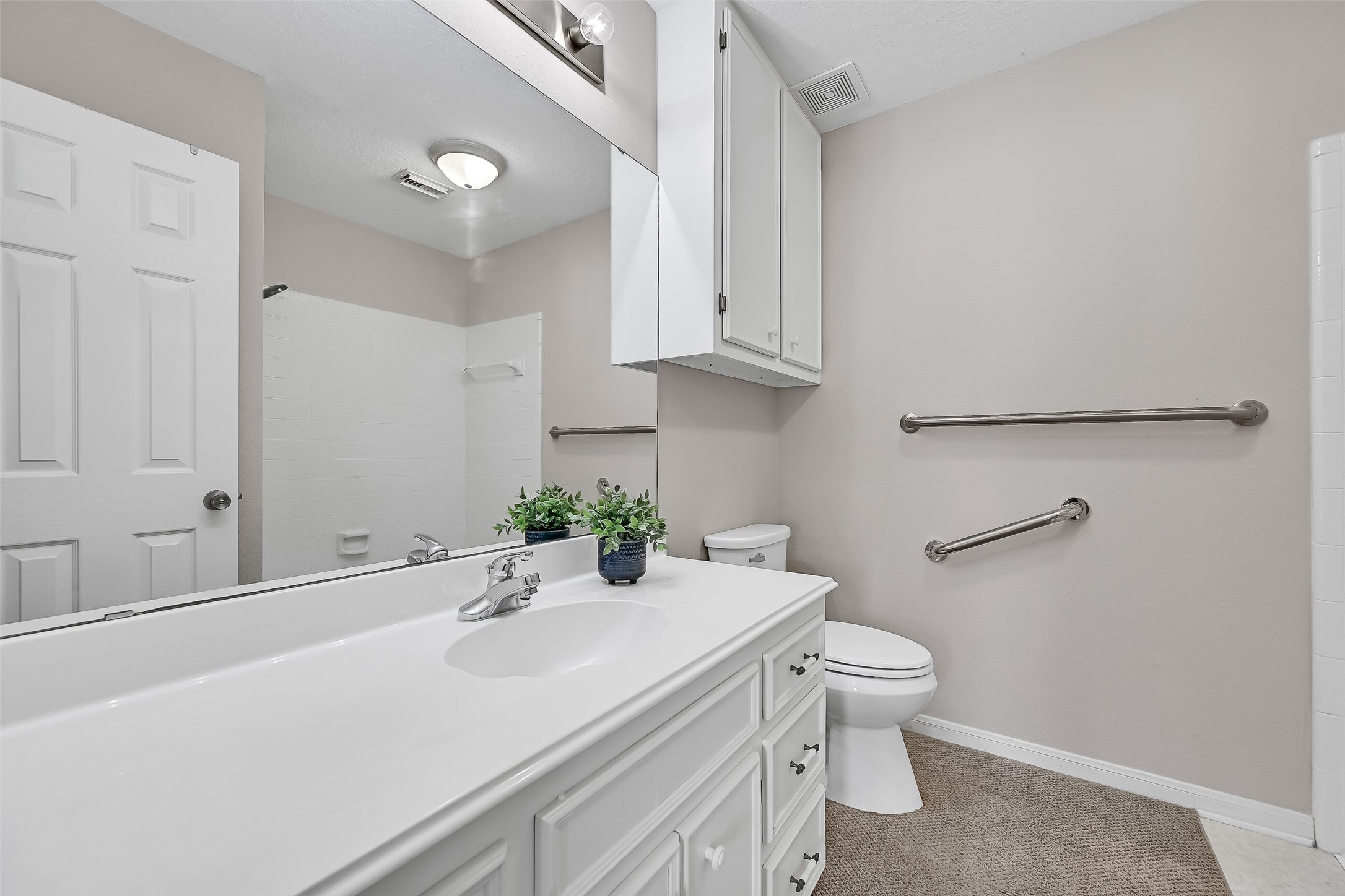 Conveniently positioned on the main level, this full bath features a spacious vanity with generous counter space, additional storage, and a neutral color palette that complements the home's recently refreshed interior.