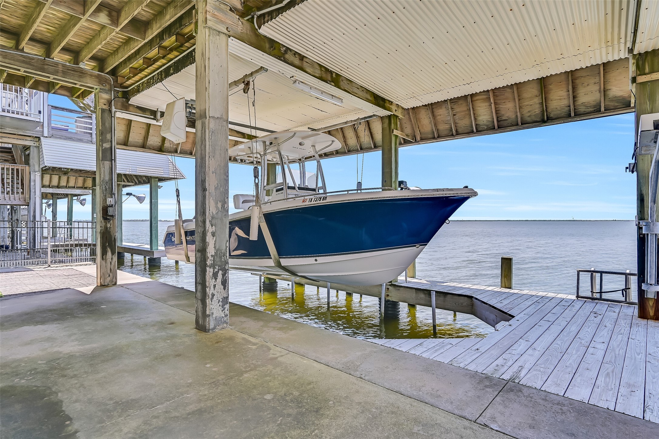Boating enthusiasts will appreciate the private covered boat lift and dock, offering convenient protected storage and immediate access to Jones Bay and West Bay beyond. Spend less time trailering and more time enjoying fishing, cruising, and exploring the Texas coast right from your own backyard.