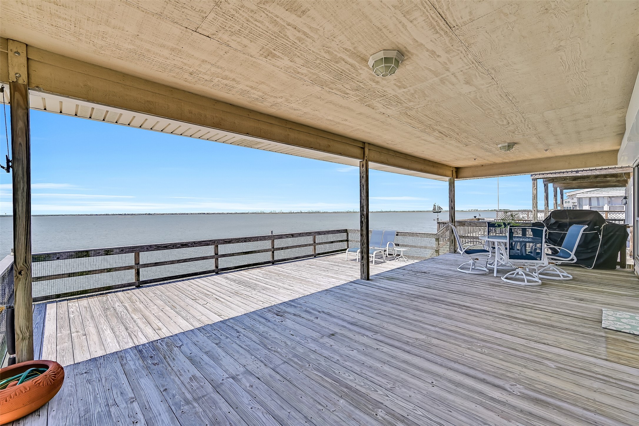 Stretching across the bayside of the home, this oversized deck offers an incredible amount of space for gathering with family and friends while enjoying unobstructed views across Jones Bay toward West Bay. Covered and open-air sections provide options for sun or shade throughout the day, while the west-facing exposure sets the stage for spectacular sunset views year-round.