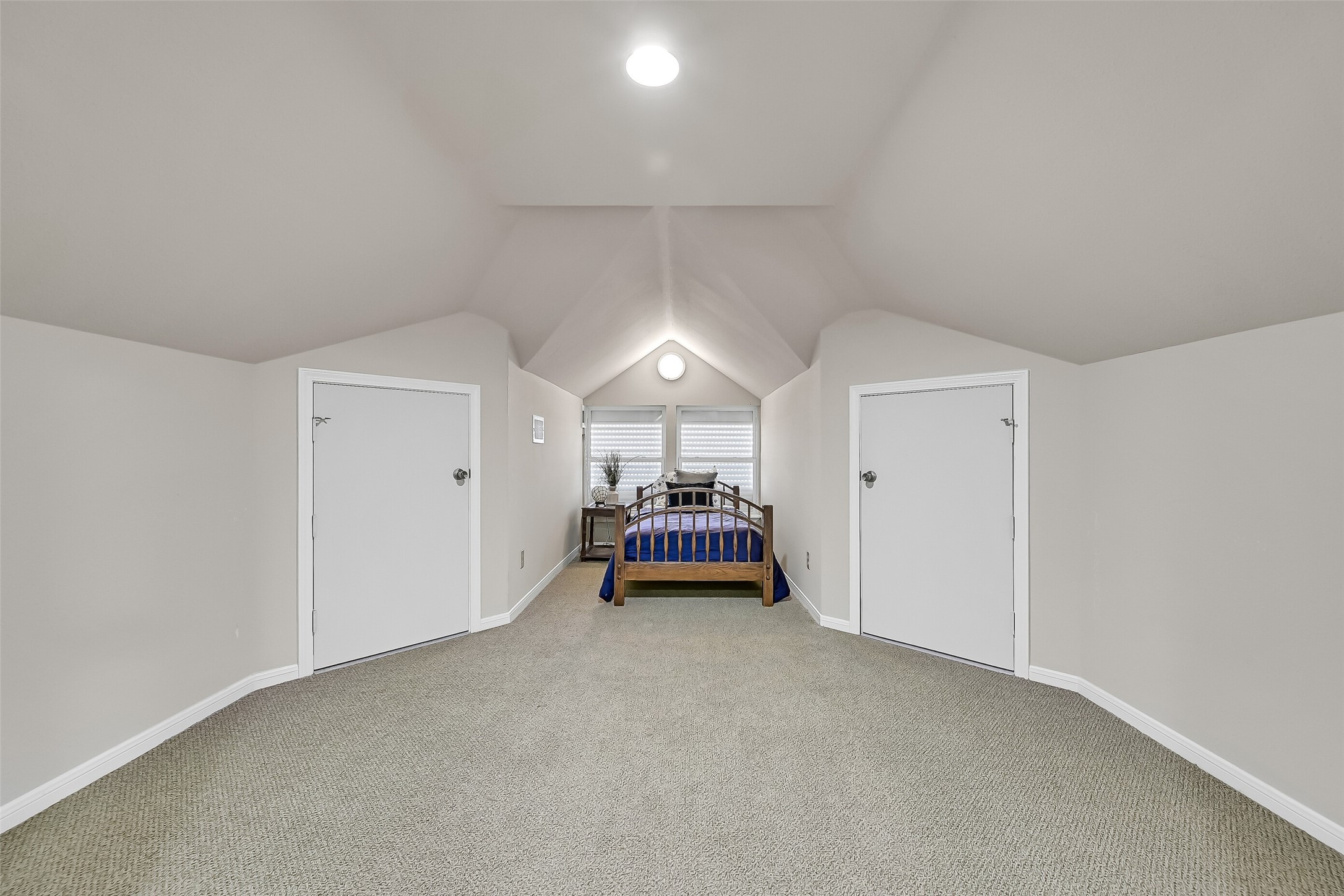 Accessible by either the staircase or elevator, the third level offers a spacious flex room with vaulted ceilings, built-in storage, and endless possibilities. Whether used as a bunk room, game room, media space, home office, or additional sleeping quarters, this versatile area easily adapts to your needs.