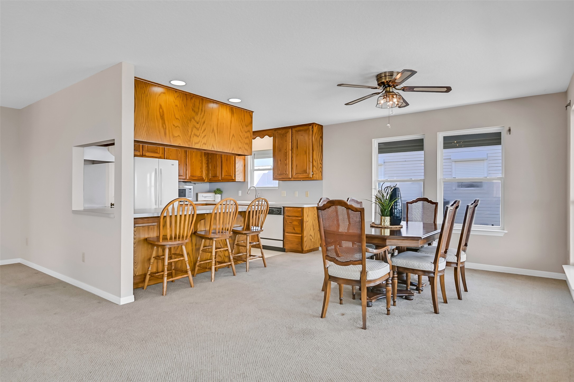 The dining area connects easily to the kitchen, making hosting family gatherings and weekend guests a breeze. Open sightlines allow conversations to flow while the surrounding windows keep the stunning waterfront scenery front and center.