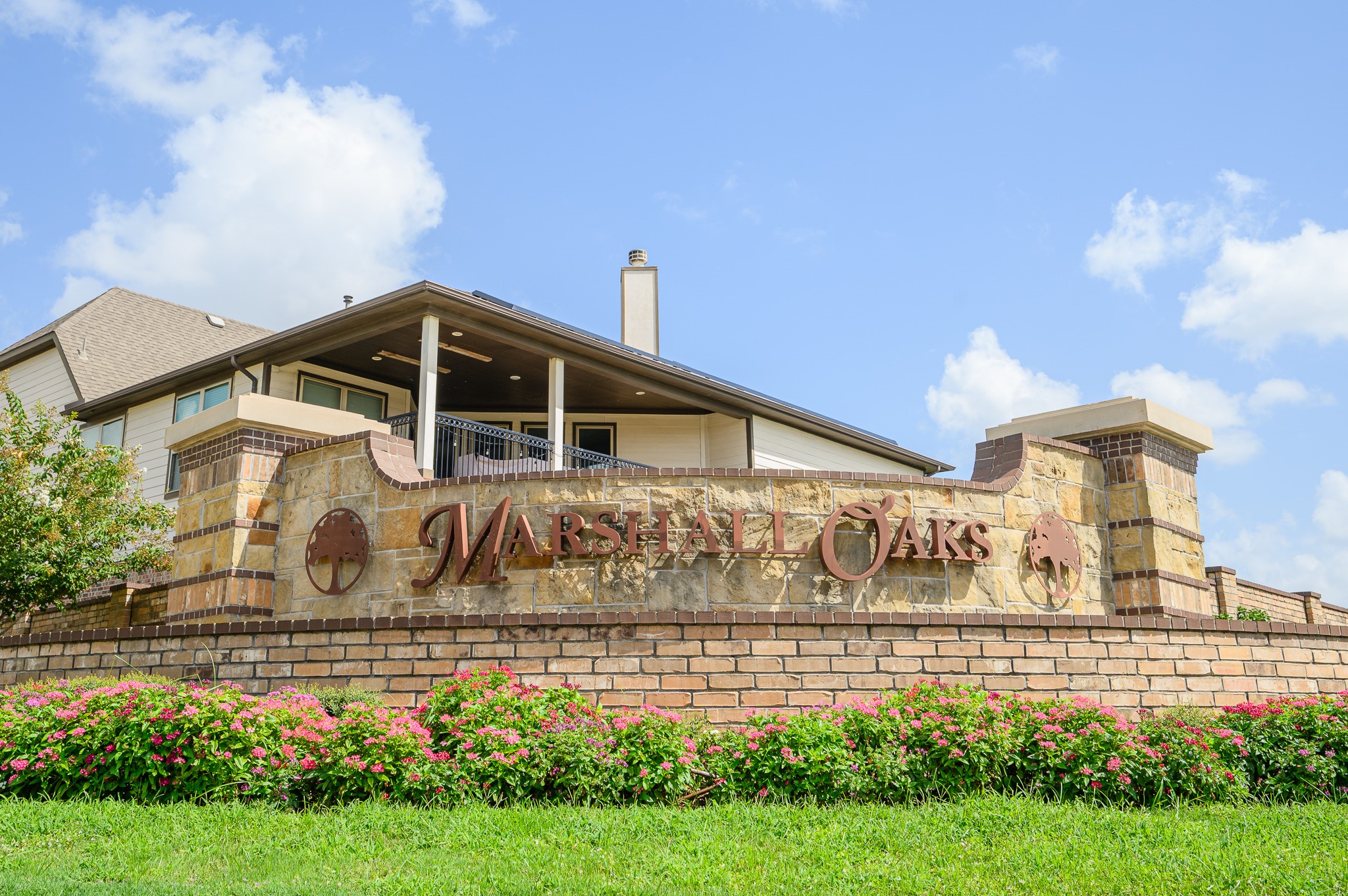 Discover the inviting charm of Marshall Oaks, where elegant stonework and lush landscaping create a serene and welcoming community ambiance.